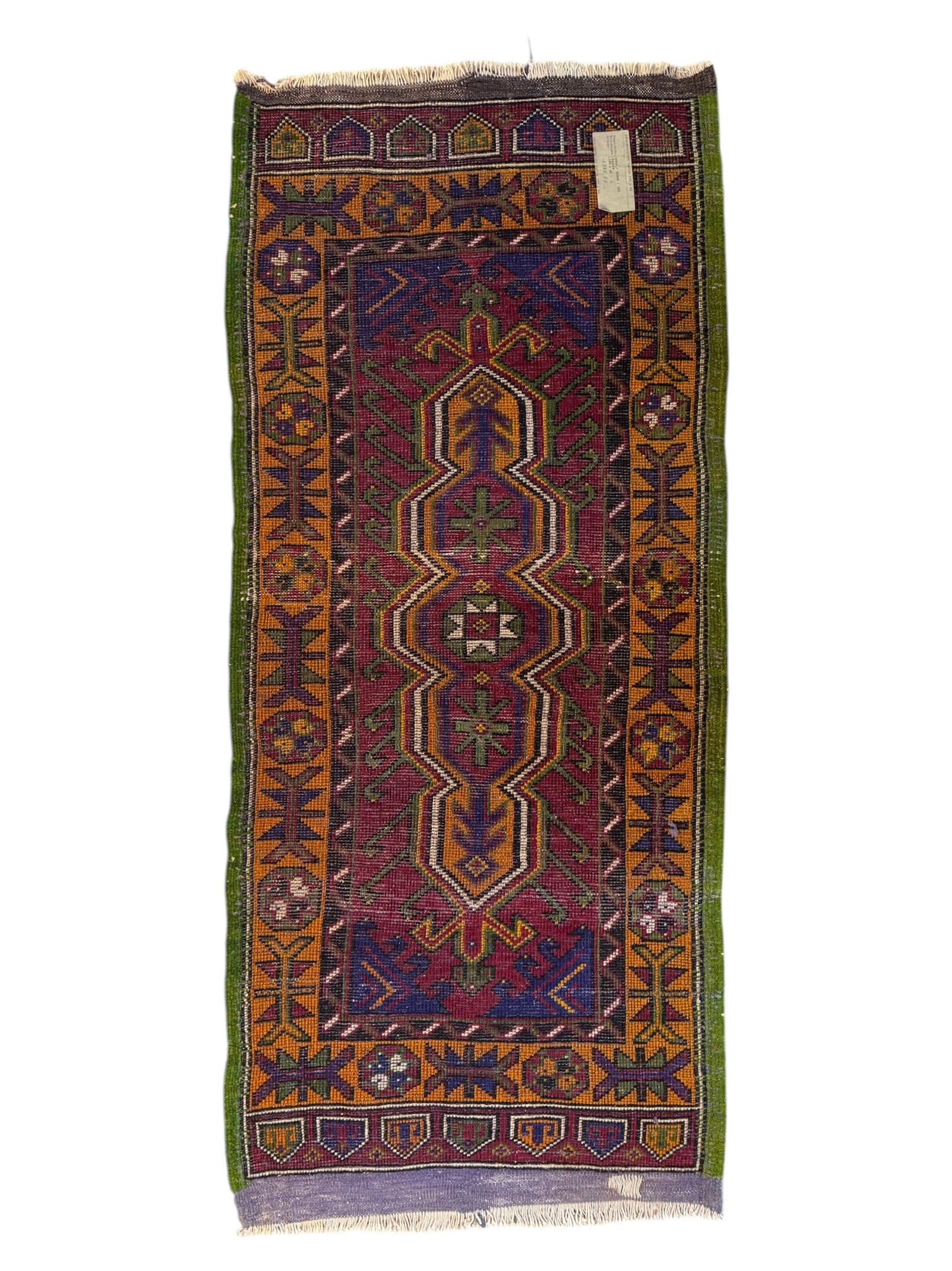 Anatolian Yastik rug with red, gold, green and gray geometric patterns and fringe.