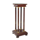 A French Empire style wooden pedestal stand with an inset marble top and gold accents on the legs and base.