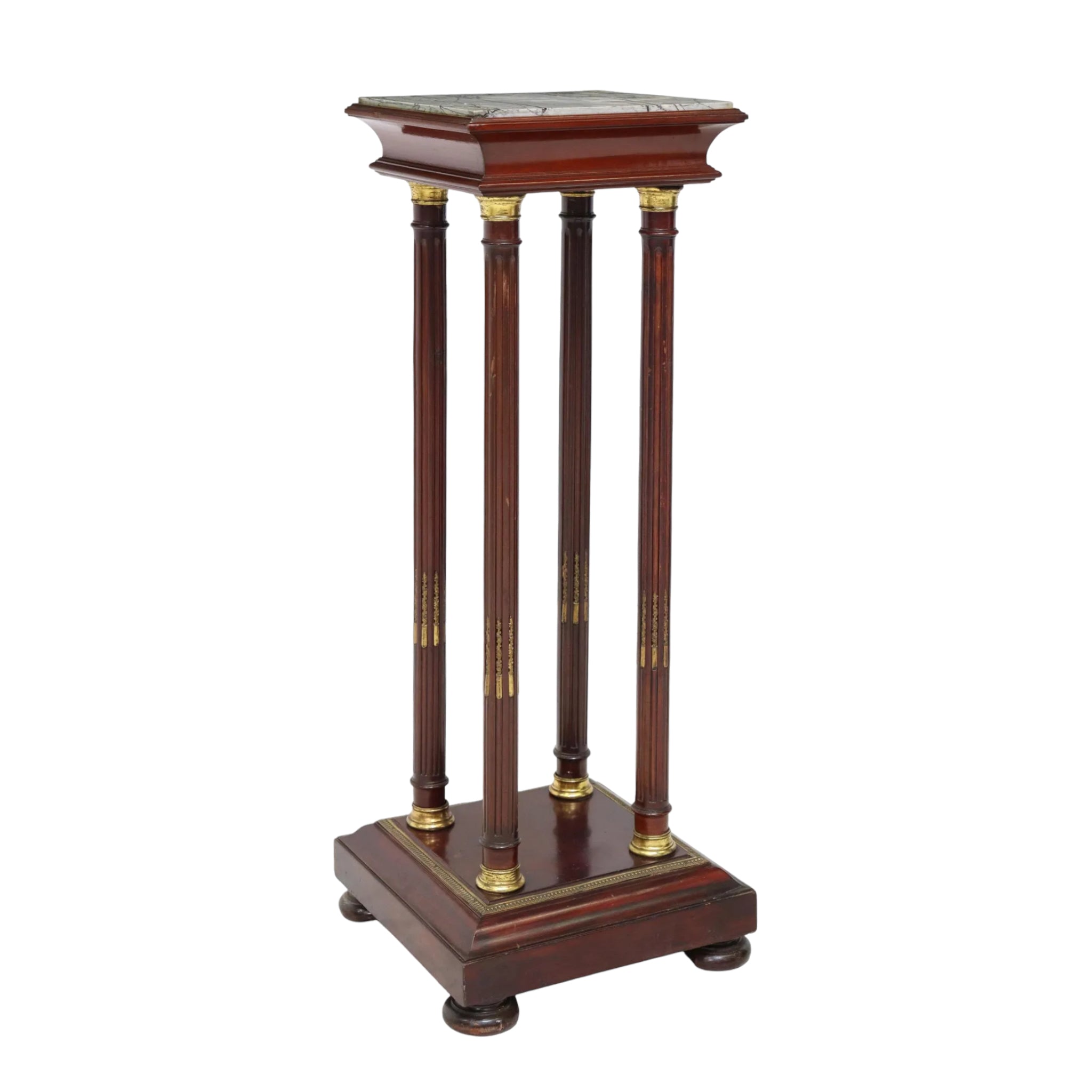 A French Empire style wooden pedestal stand with an inset marble top and gold accents on the legs and base.