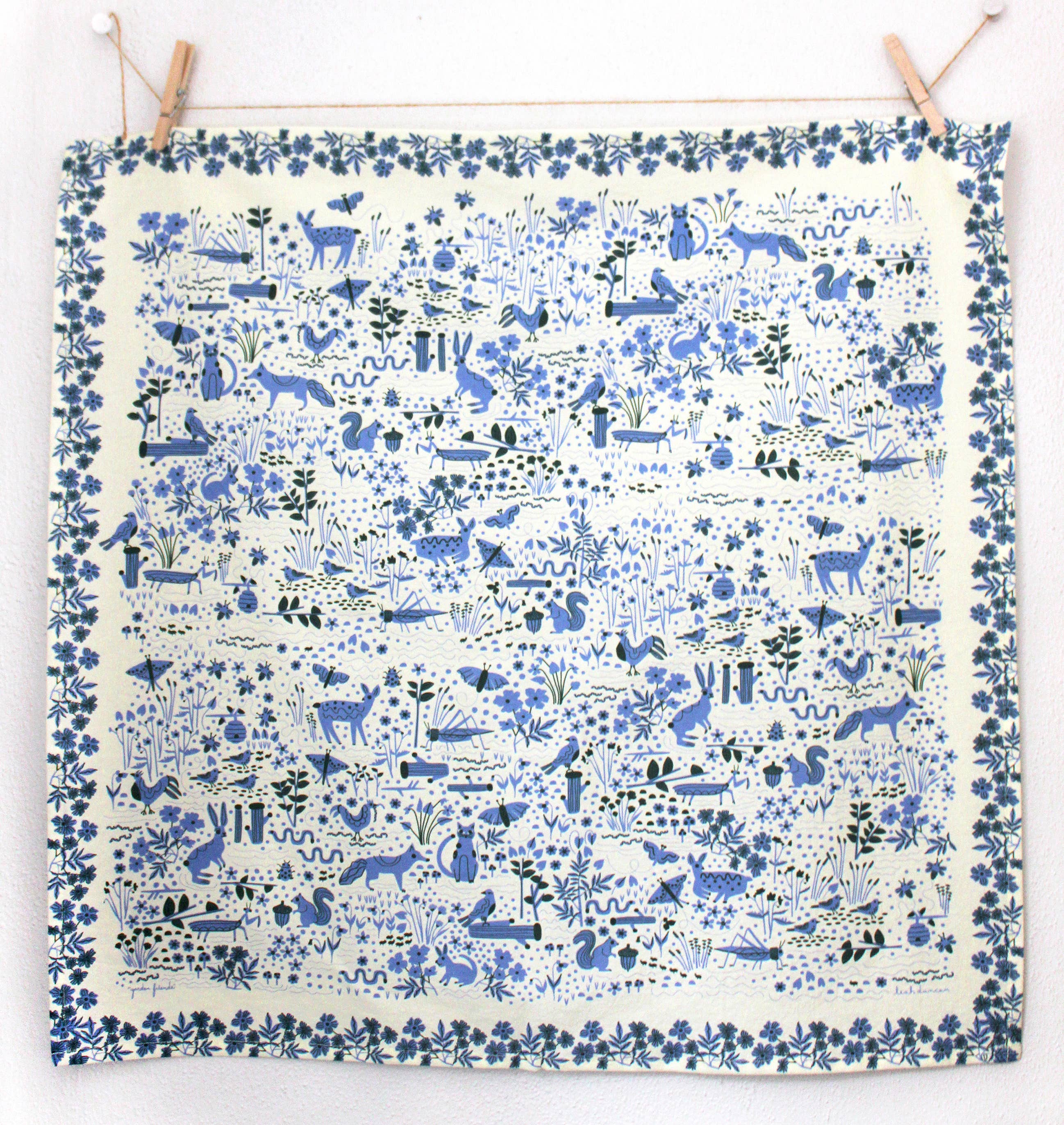 Fabric with blue animal and nature pattern on a white background