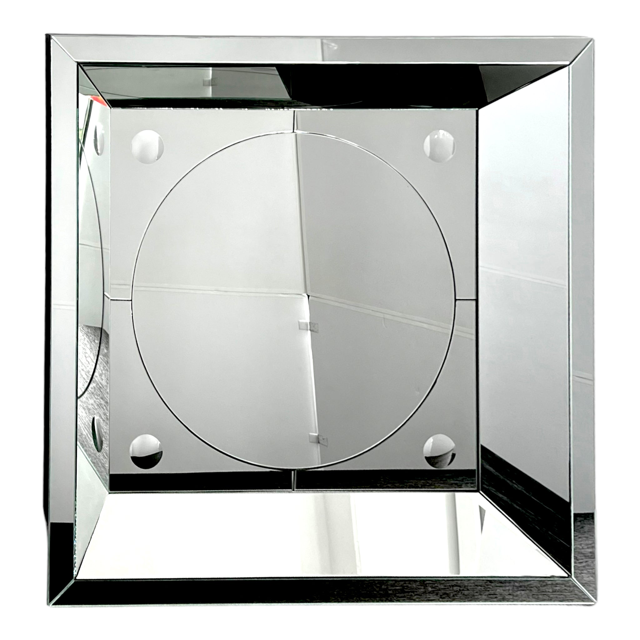 A vintage style geometric square mirror with a silver frame and reflective surface, showing signs of wear.