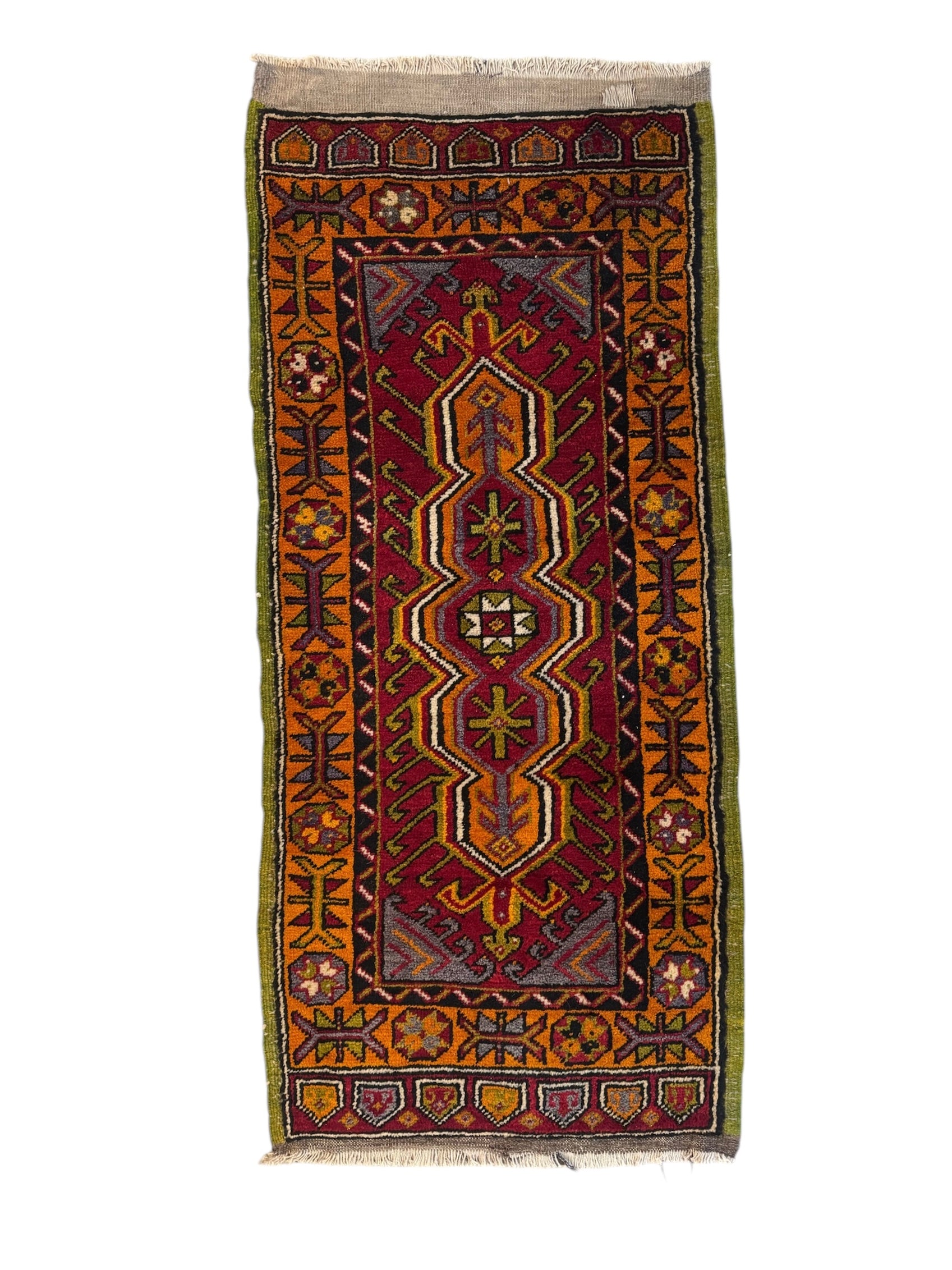 Anatolian Yastik rug with red, gold, green and gray geometric patterns and fringe.