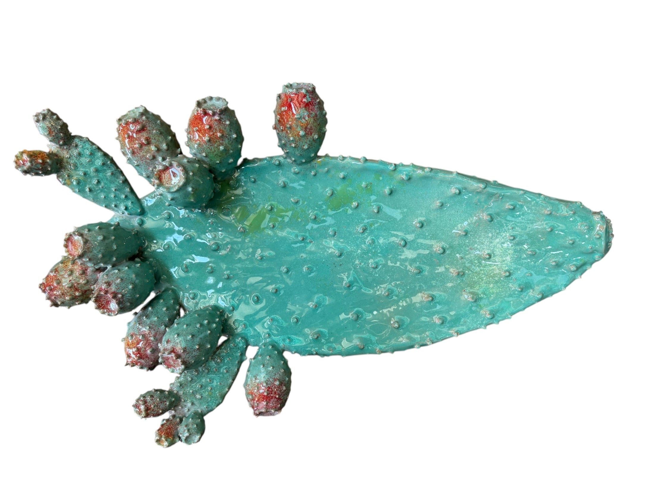A green and red, glazed ceramic platter in the shape of a prickly pear cactus pad with attached prickly pear fruit. The surface has raised dots representing spines. 
Handmade Green Cactus Platter with Red Accents- Italian Design by Enza Fasano Ceramiche