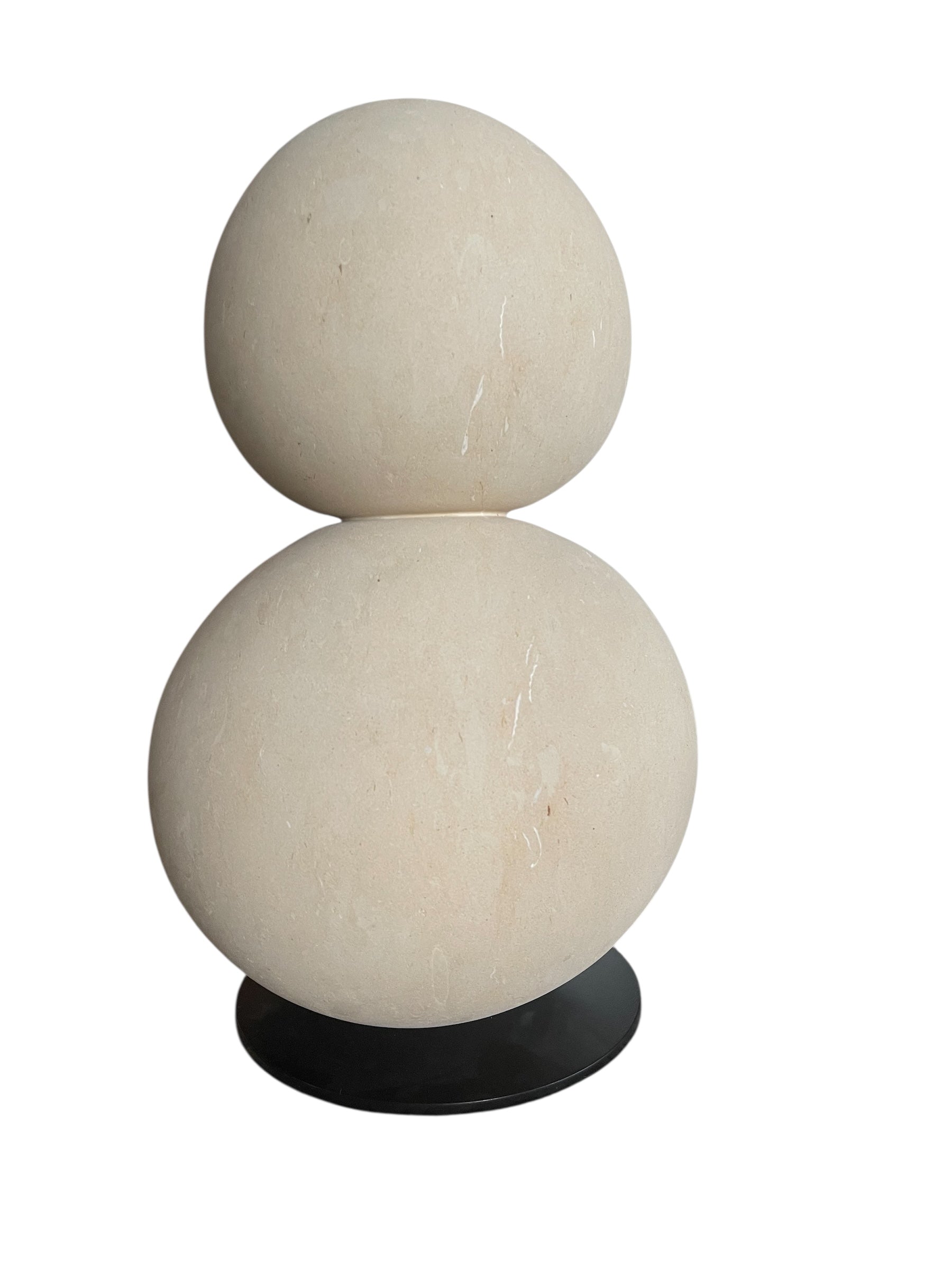 "Renzo Buttazzo's 'Lovers,' a sculpture made from Pietra Leccese featuring two stacked, rounded forms with subtle projections, on a black base."
"Modern sculpture of two smooth, light-colored forms stacked on top of each other, with a small horn-like protrusion on each."