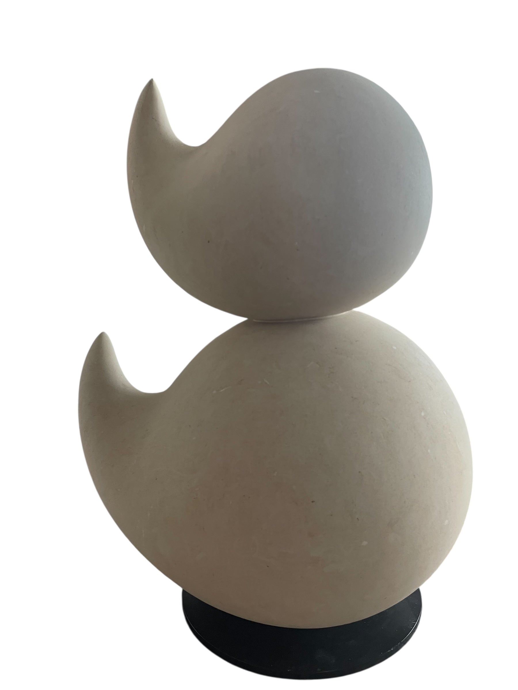 "Renzo Buttazzo's 'Lovers,' a sculpture made from Pietra Leccese featuring two stacked, rounded forms with subtle projections, on a black base."
"Modern sculpture of two smooth, light-colored forms stacked on top of each other, with a small horn-like protrusion on each."