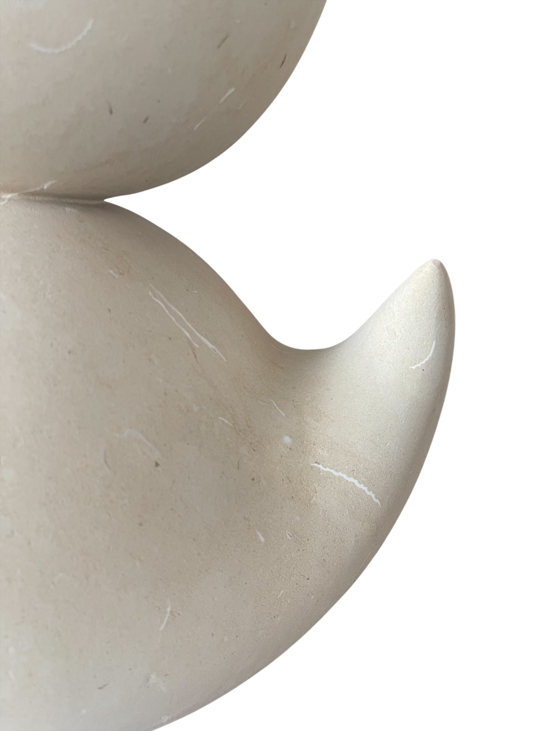 "Renzo Buttazzo's 'Lovers,' a sculpture made from Pietra Leccese featuring two stacked, rounded forms with subtle projections, on a black base."
"Modern sculpture of two smooth, light-colored forms stacked on top of each other, with a small horn-like protrusion on each."
