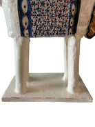 Ceramic horse by Domenico Pinto, featuring a white glazed body, geometric quilting on the saddle, gold accents, and 24Kt gold detailing. The horse stands on four legs and is placed on a white base.