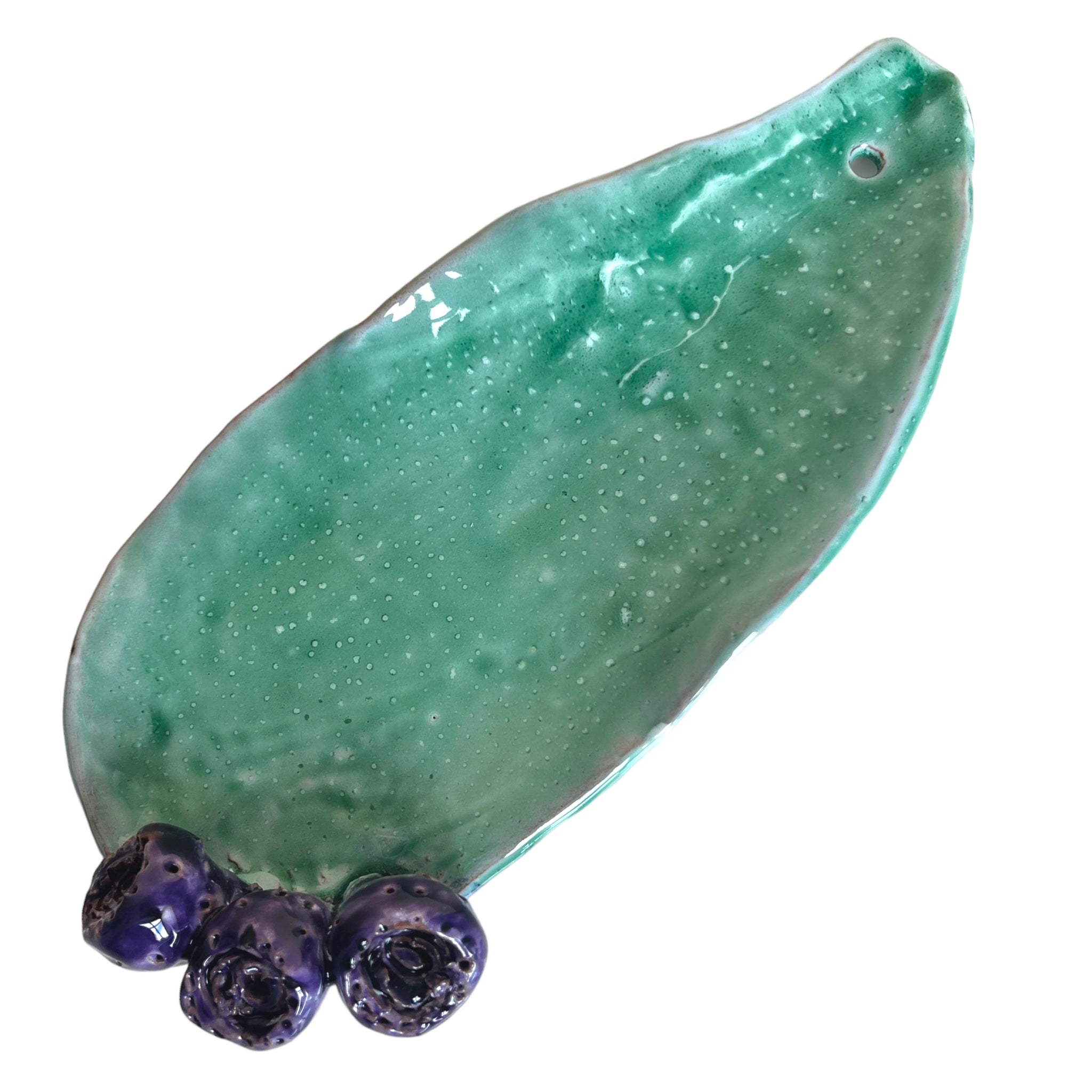 A ceramic cactus with green body and three purple prickly pears on top, signed by Francesco Petracca.