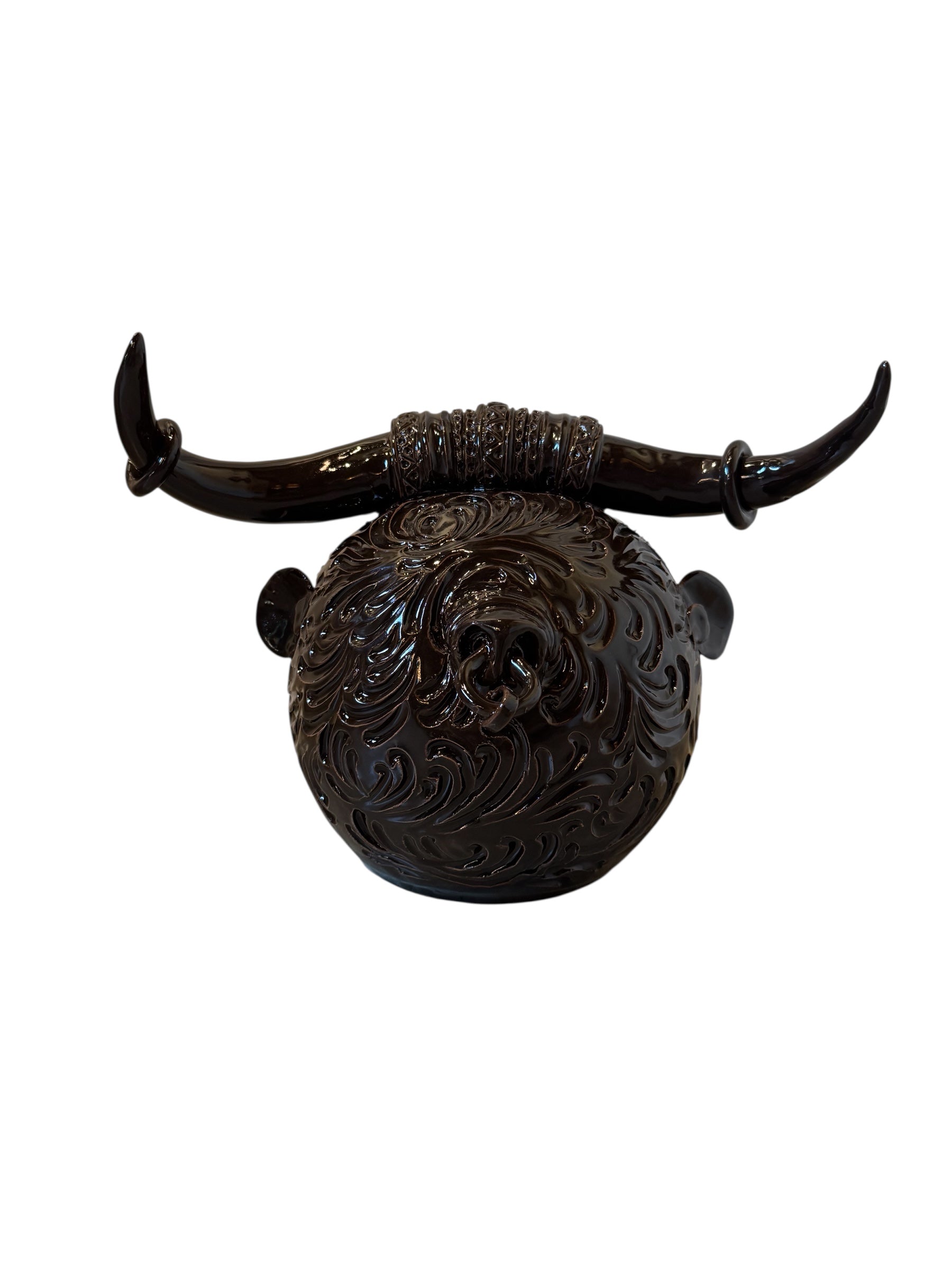 Glossy dark brown ceramic bull sculpture with intricate, hand-incised swirling patterns and a nose ring.