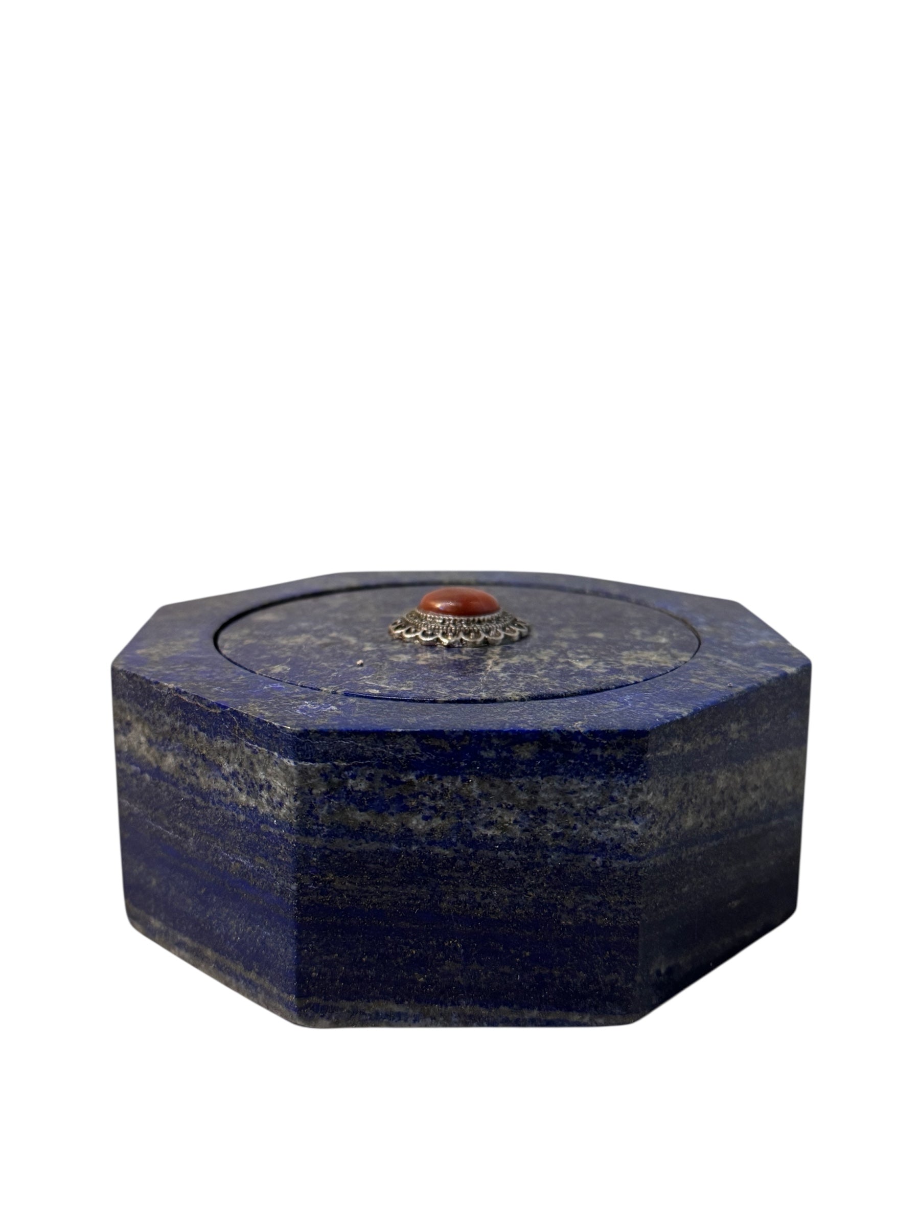 Hand-carved octagonal box made of lapis lazuli, featuring a red cabochon stone on its lid.
Lapis Lazuli Keepsake Box with a round Carnelian Cabochon Stone.