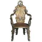 A Barroco style carved gilt armchair with gold and silver accents, intricate hand-painted motifs, and a shell-back design.
Magical Venetian carved gilt grotto armchair