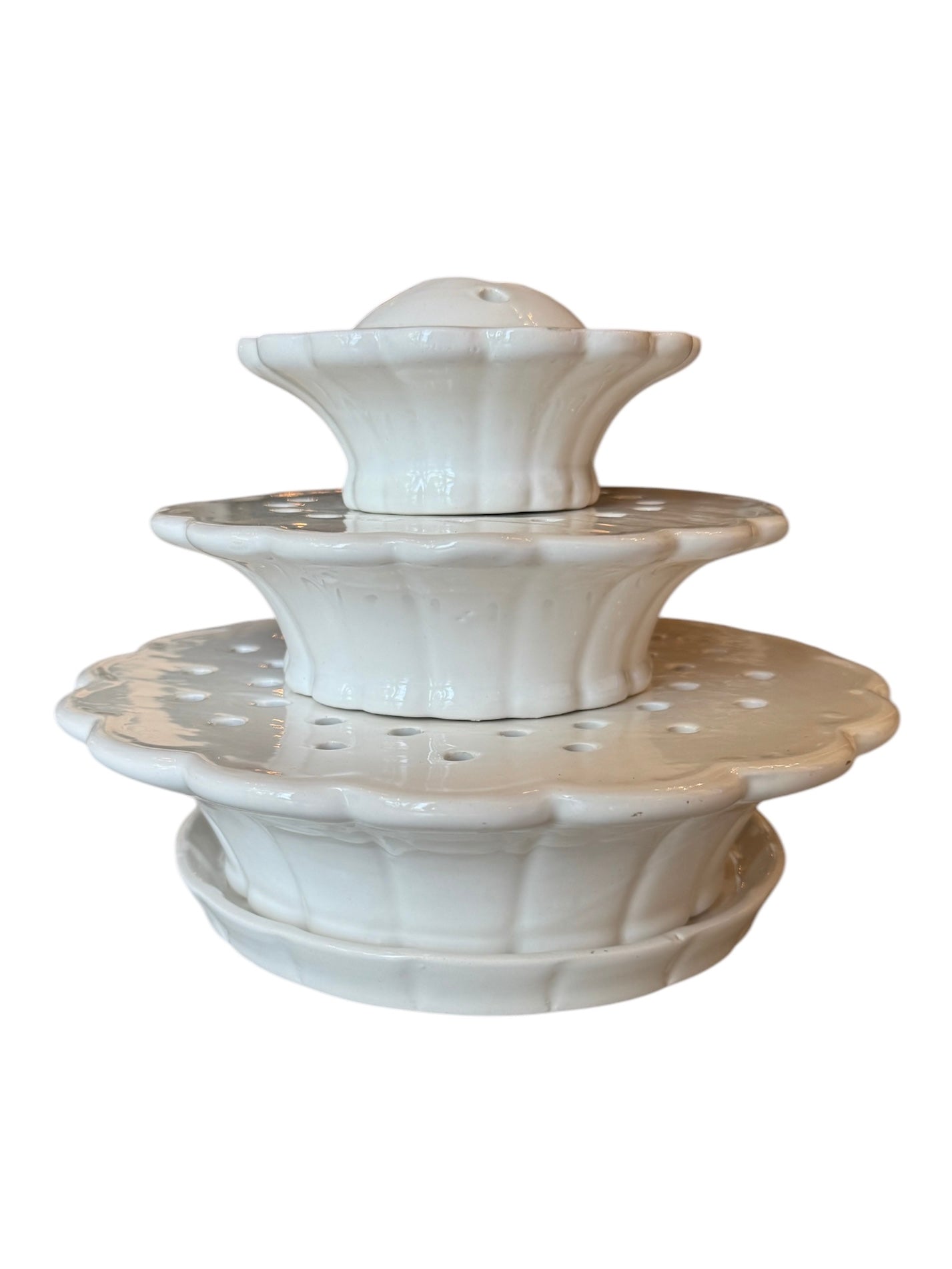 A white ceramic tiered flower frog vase with scalloped edges and holes for floral arrangement, from the Martha Stewart by Mail collection.