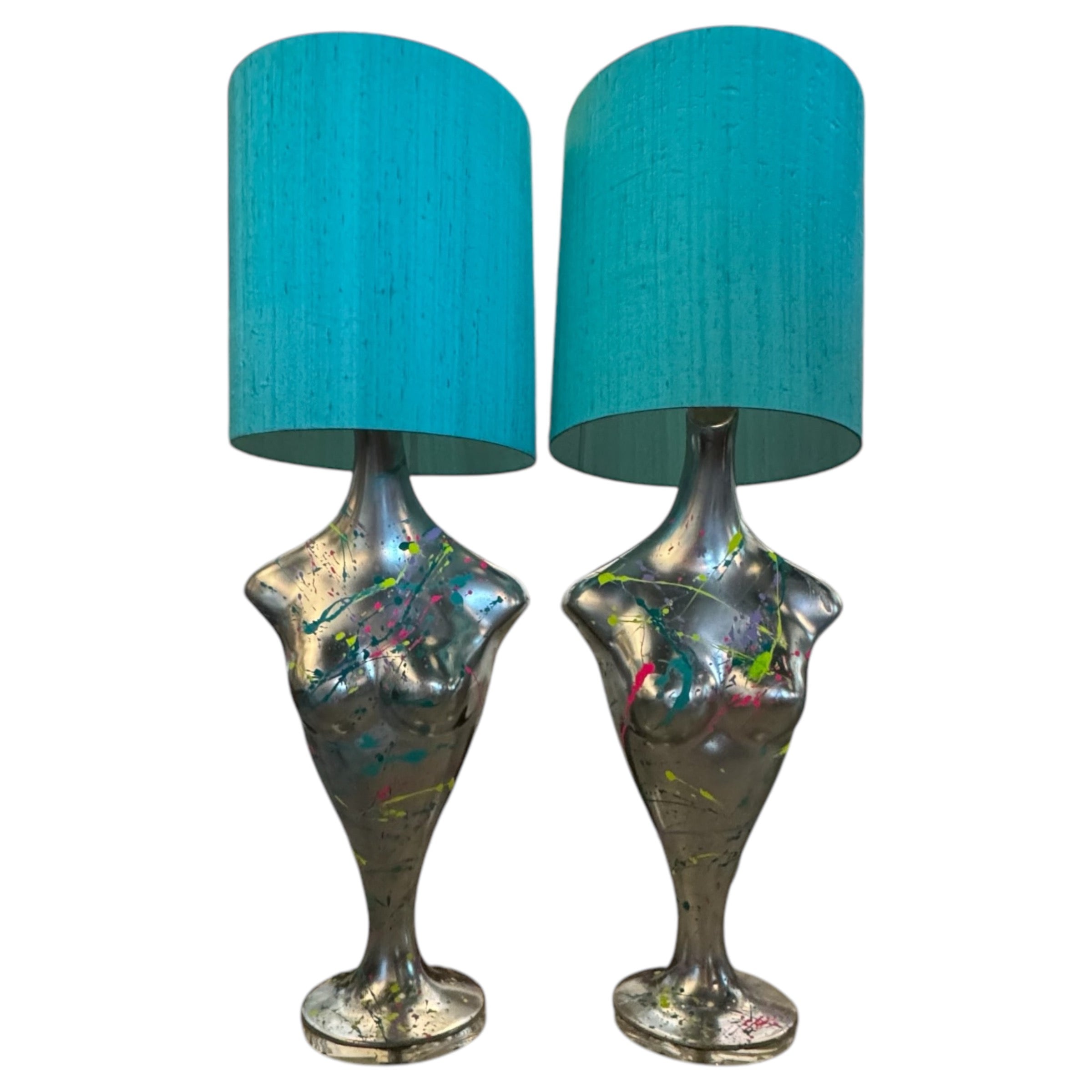 A pair of female bust table lamps with silver metallic bases and turquoise Dupion silk shades.