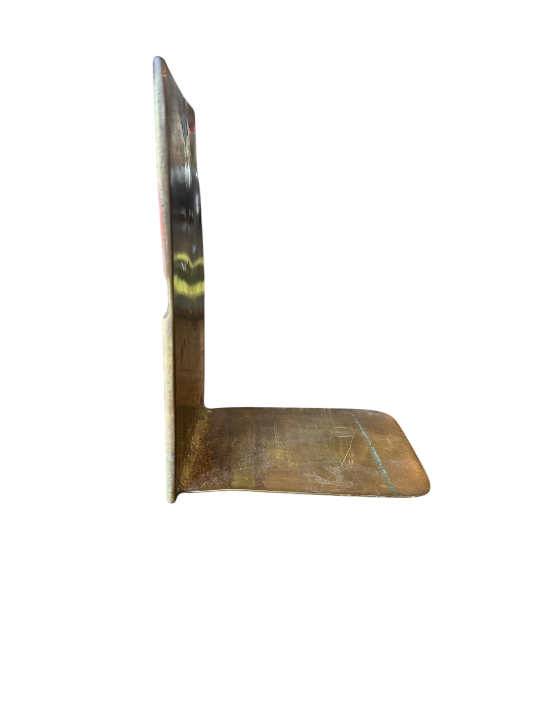 Close-up of two David Marshall Brutalist bookends. The bookends feature contrasting silver and bronze metal panels, separated by raised textured bronze seams. The bookends have a rough, geometric design.