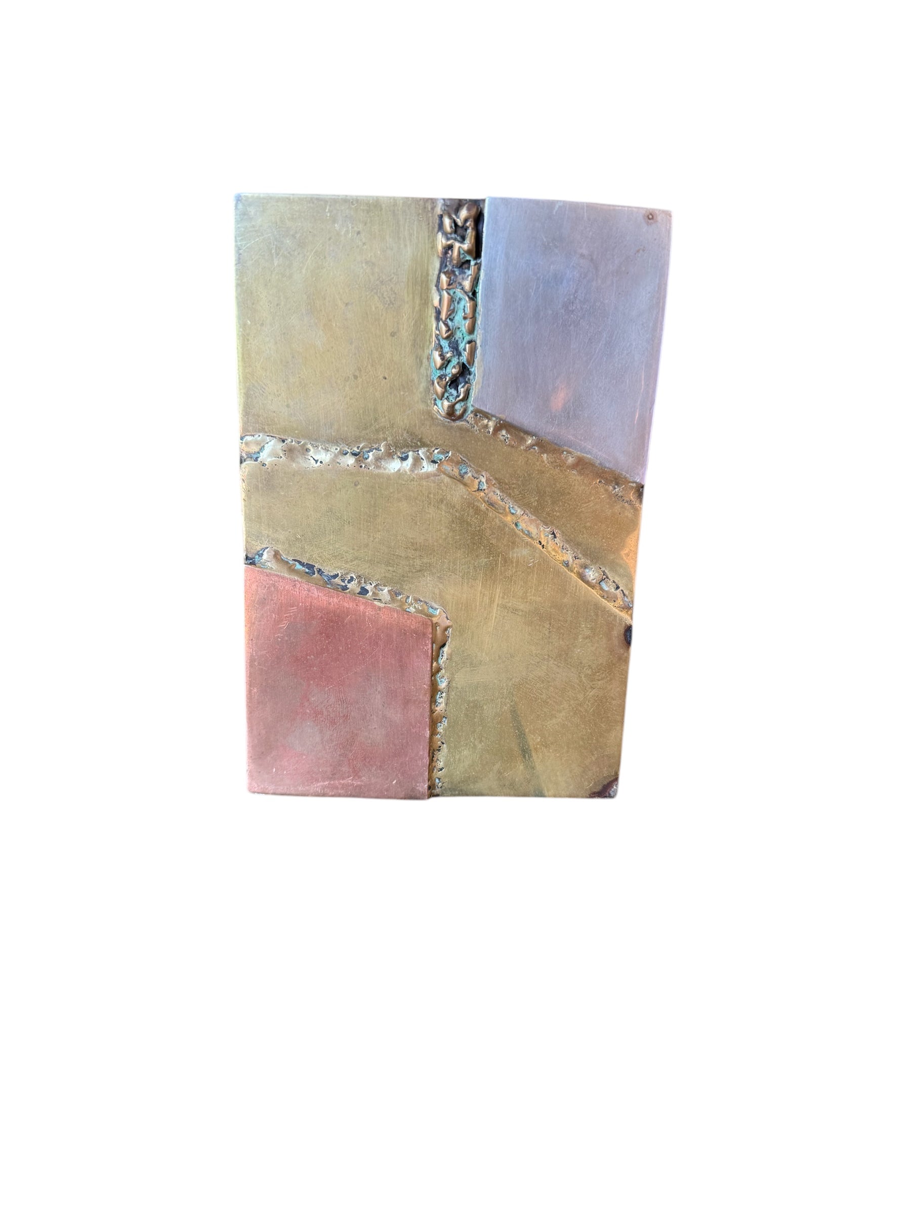 Close-up of two David Marshall Brutalist bookends. The bookends feature contrasting silver and bronze metal panels, separated by raised textured bronze seams. The bookends have a rough, geometric design.