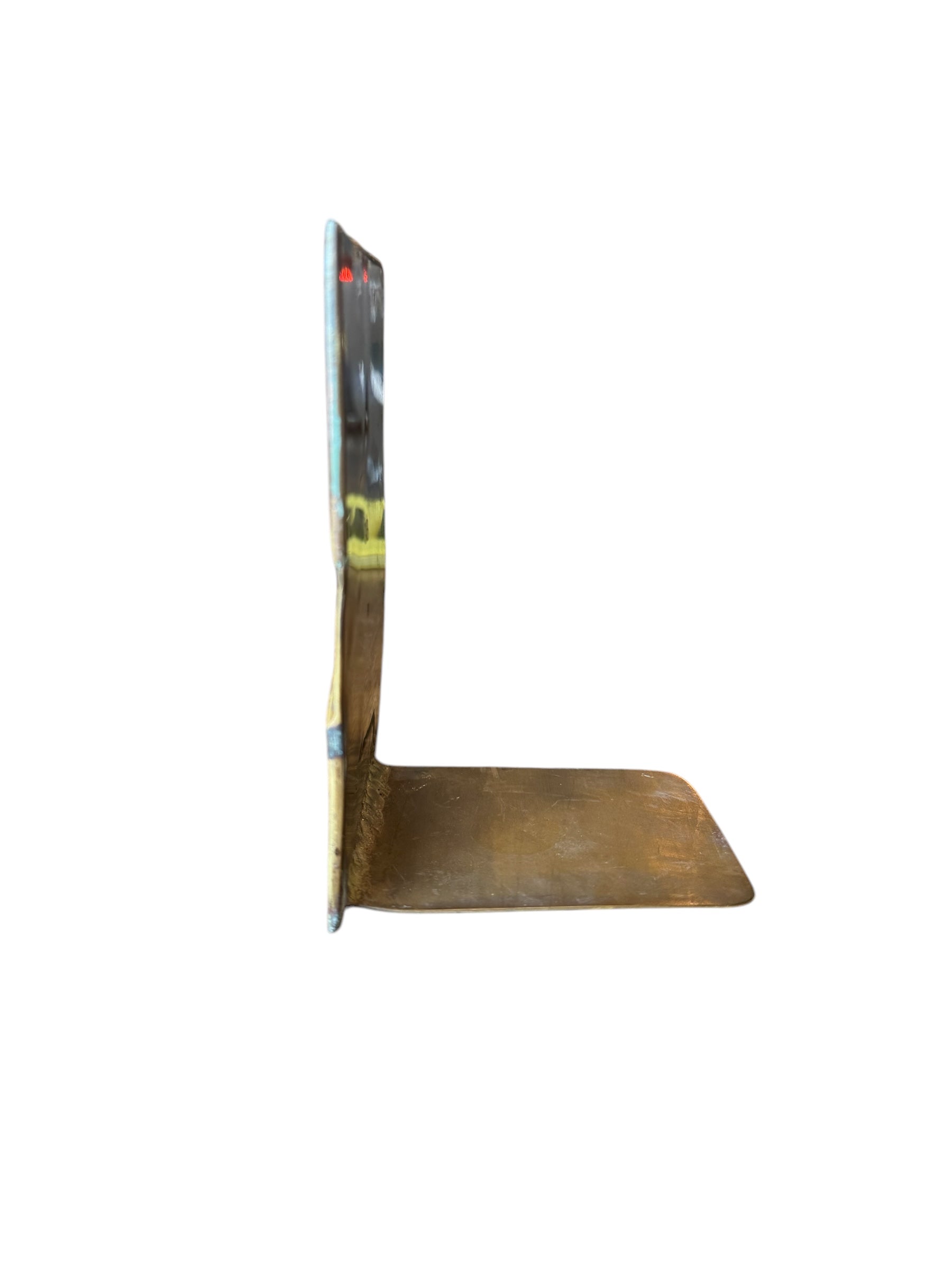 Close-up of two David Marshall Brutalist bookends. The bookends feature contrasting silver and bronze metal panels, separated by raised textured bronze seams. The bookends have a rough, geometric design.