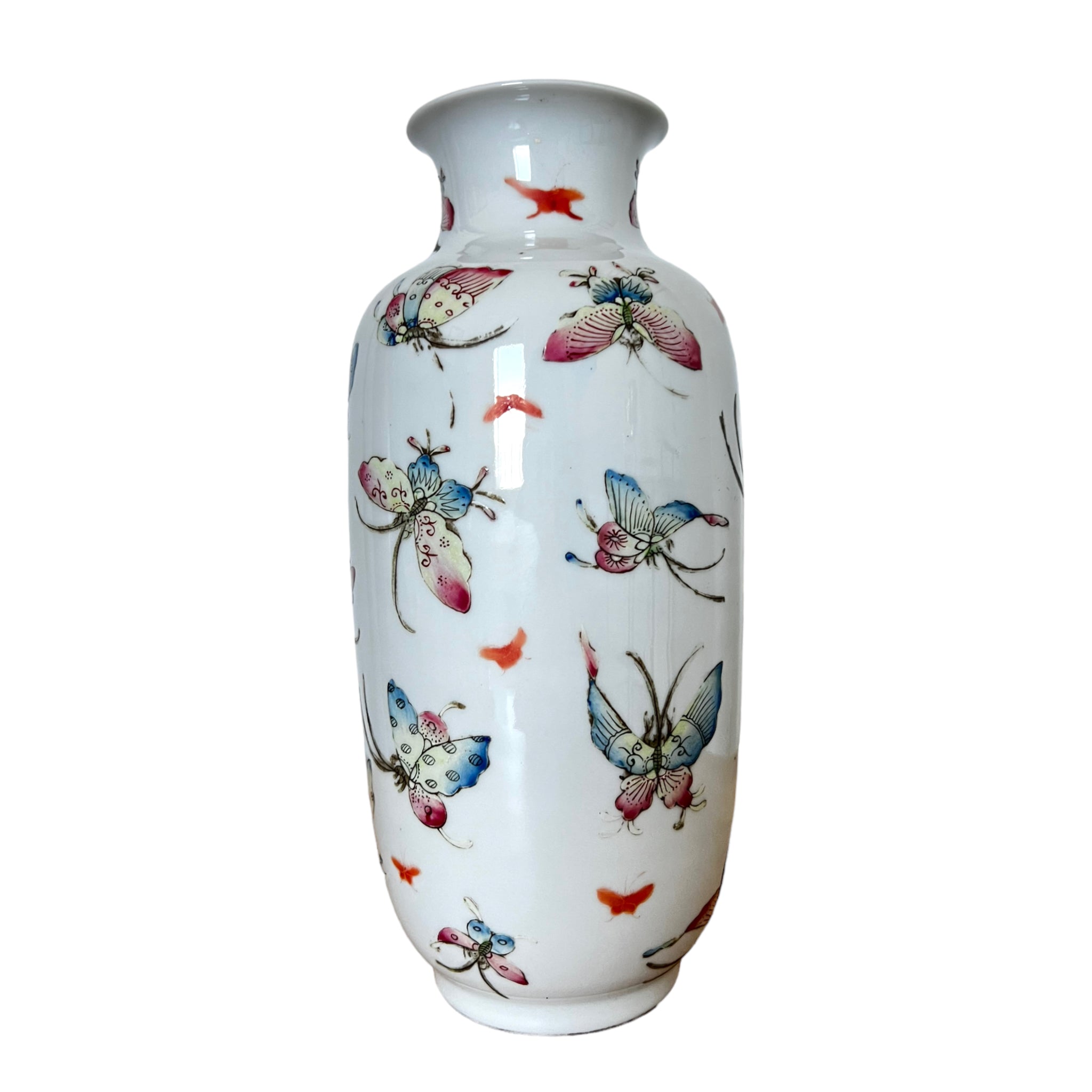A Qing Dynasty white porcelain vase with a floral and butterfly motif, featuring detailed painting in pink, blue, and yellow.
