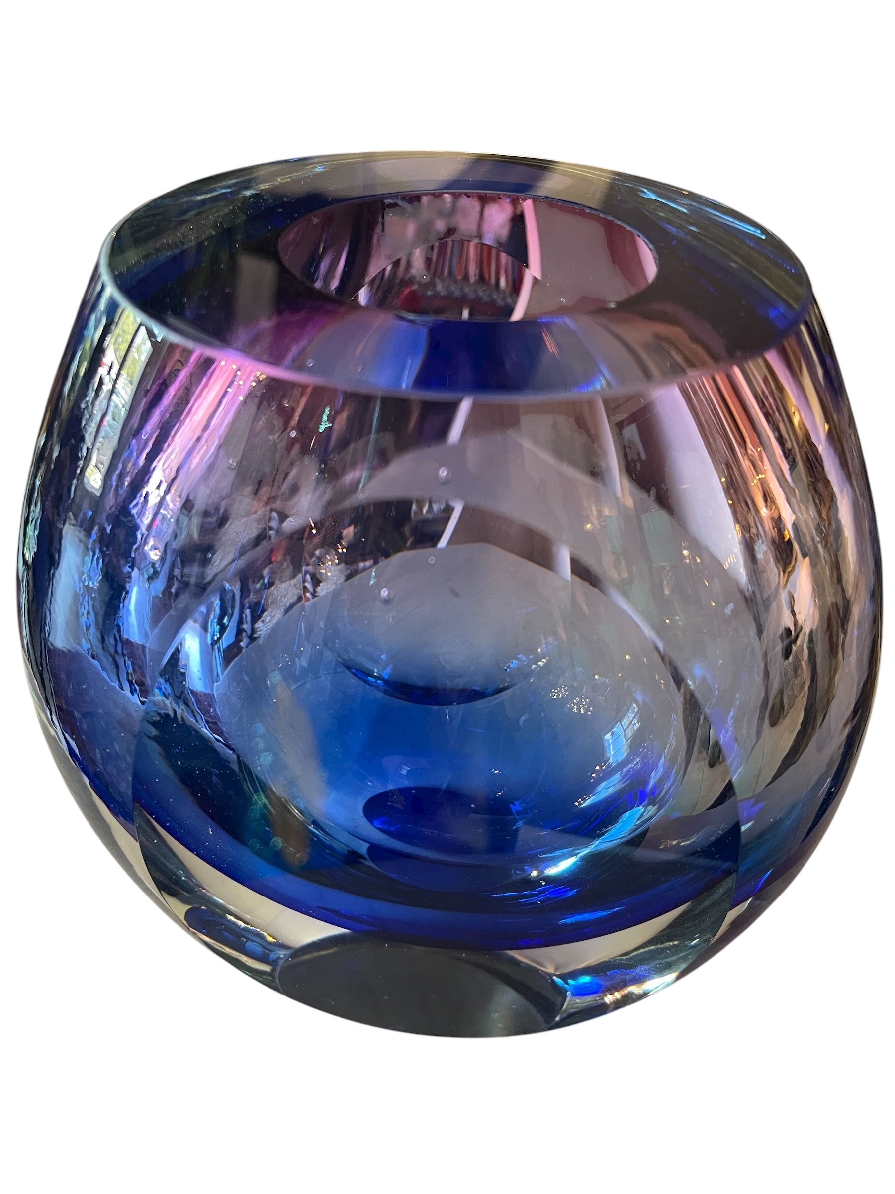 Sommerso glass vase with flattened sides creating a fish-eye effect, featuring cobalt and indigo colors and internal bubbles.