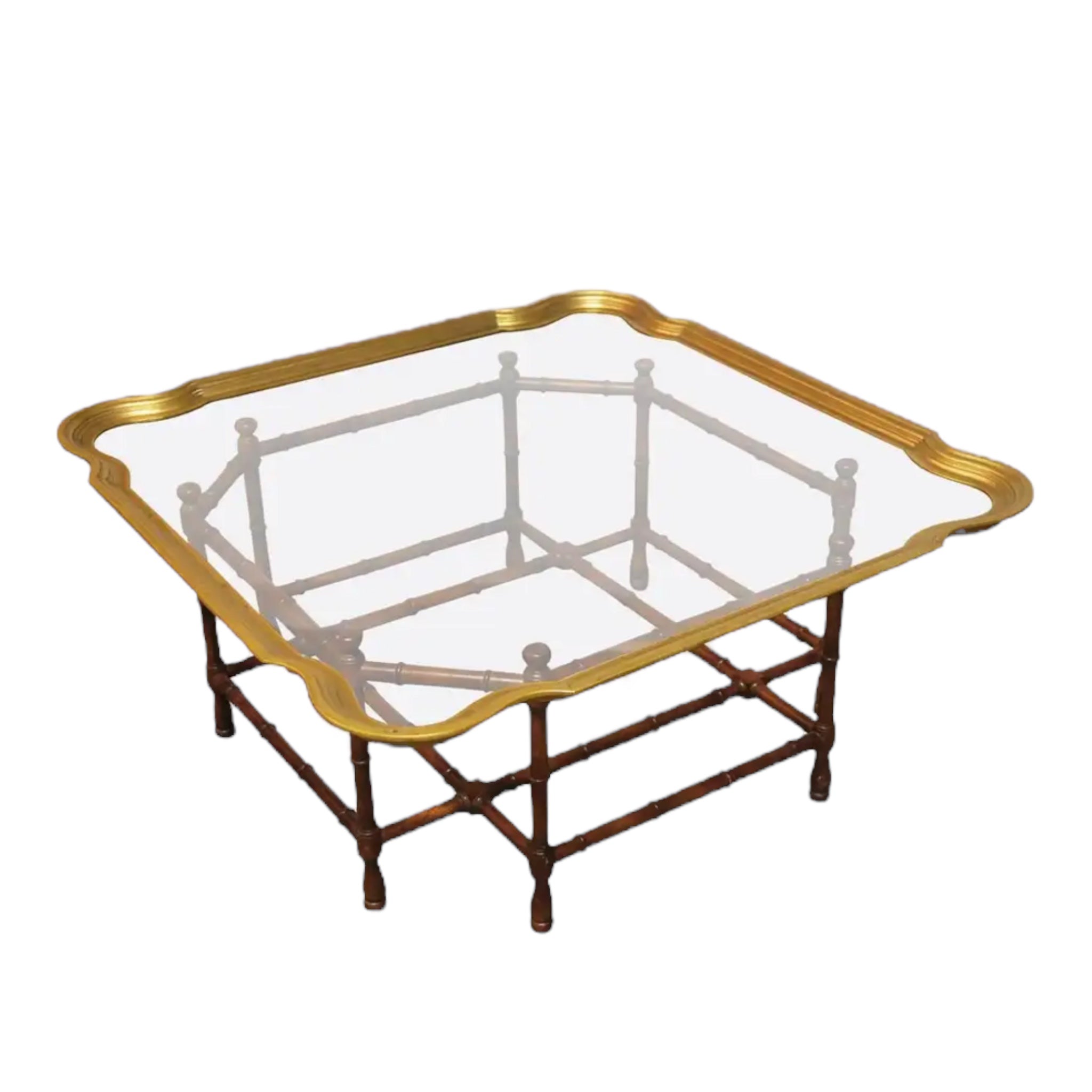 A scalloped brass coffee table with a faux bamboo wood base and a glass tray top, featuring a molded serpentine border. Baker furniture.