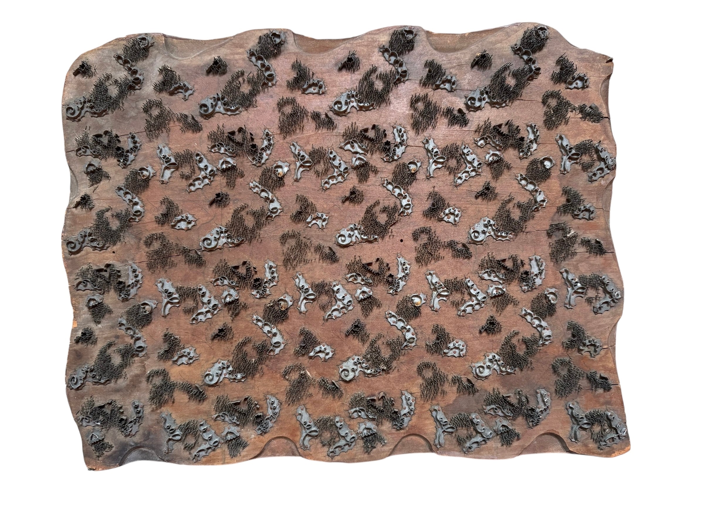 A vintage carved wooden printing block with intricate, repeating patterns, engraved with an unknown artist's signature and stamped "Made in France." The wood shows signs of age and wear, adding to its historical character.
Vintage French Carved Wooden Printing Block , 19th Century