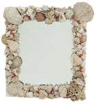 A vintage grotto shell mirror with a reflective surface surrounded by shells and small ceramic coral pieces, showcasing a natural coastal theme.