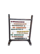 A vintage Mongolian counting frame with wooden beads in various colors strung across a wooden frame.