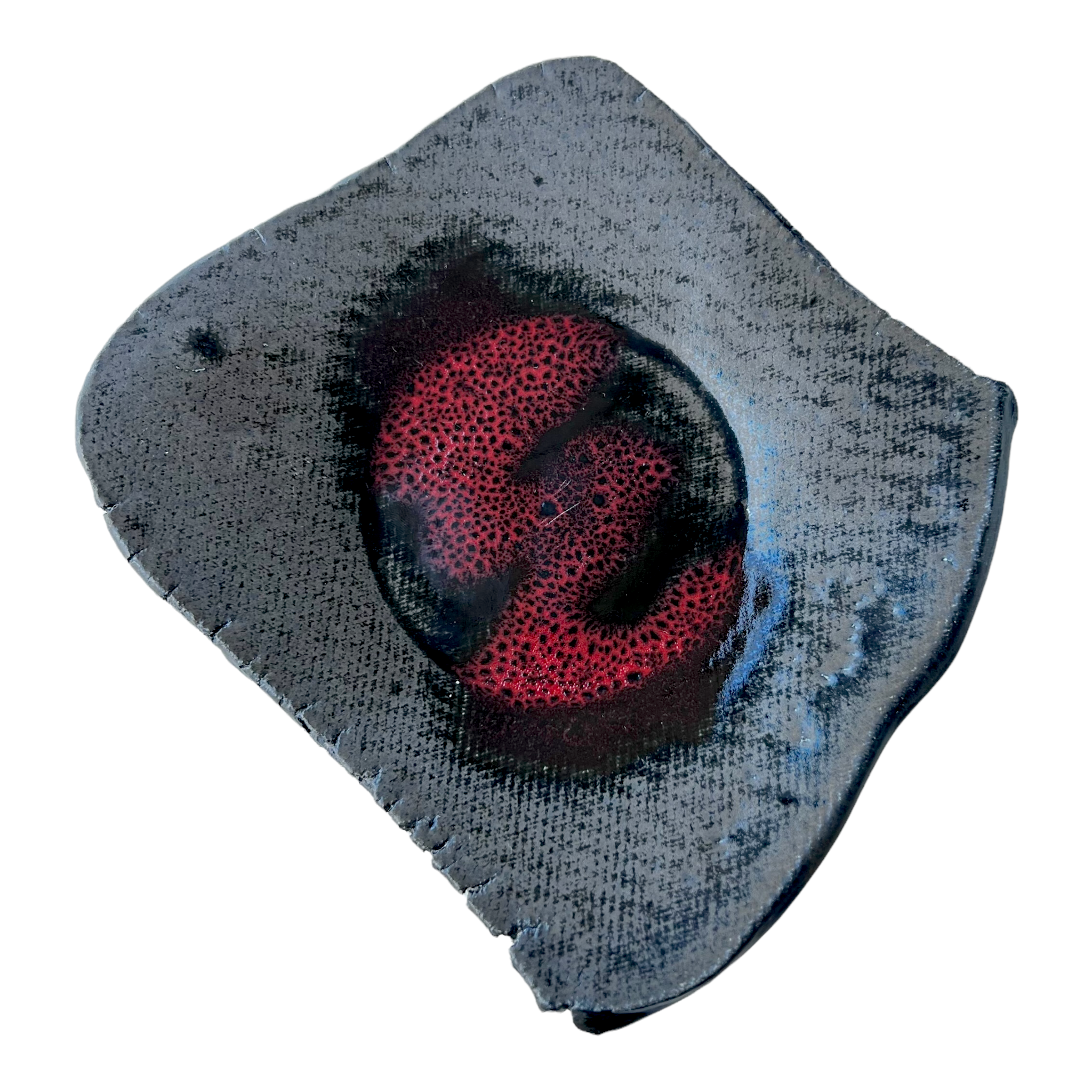 A black ceramic accent plate with a glossy texture and a red cobalt organic center, slightly turned up corners, and marked by the artist, Rick Van Dyke.