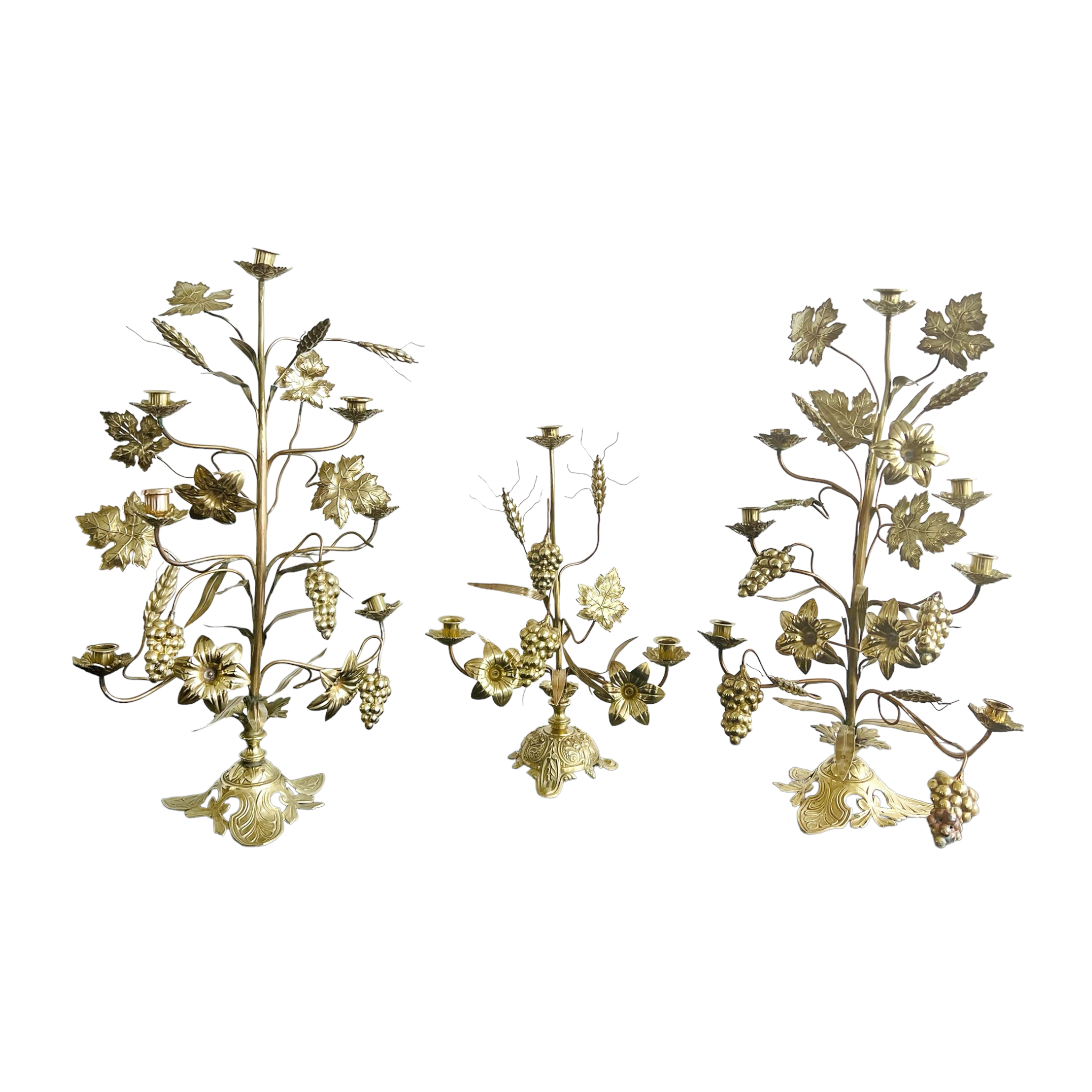 Three antique French brass and copper candelabras with a harvest motif, including wheat, grapes, and lily blossoms, with a cross on the base.