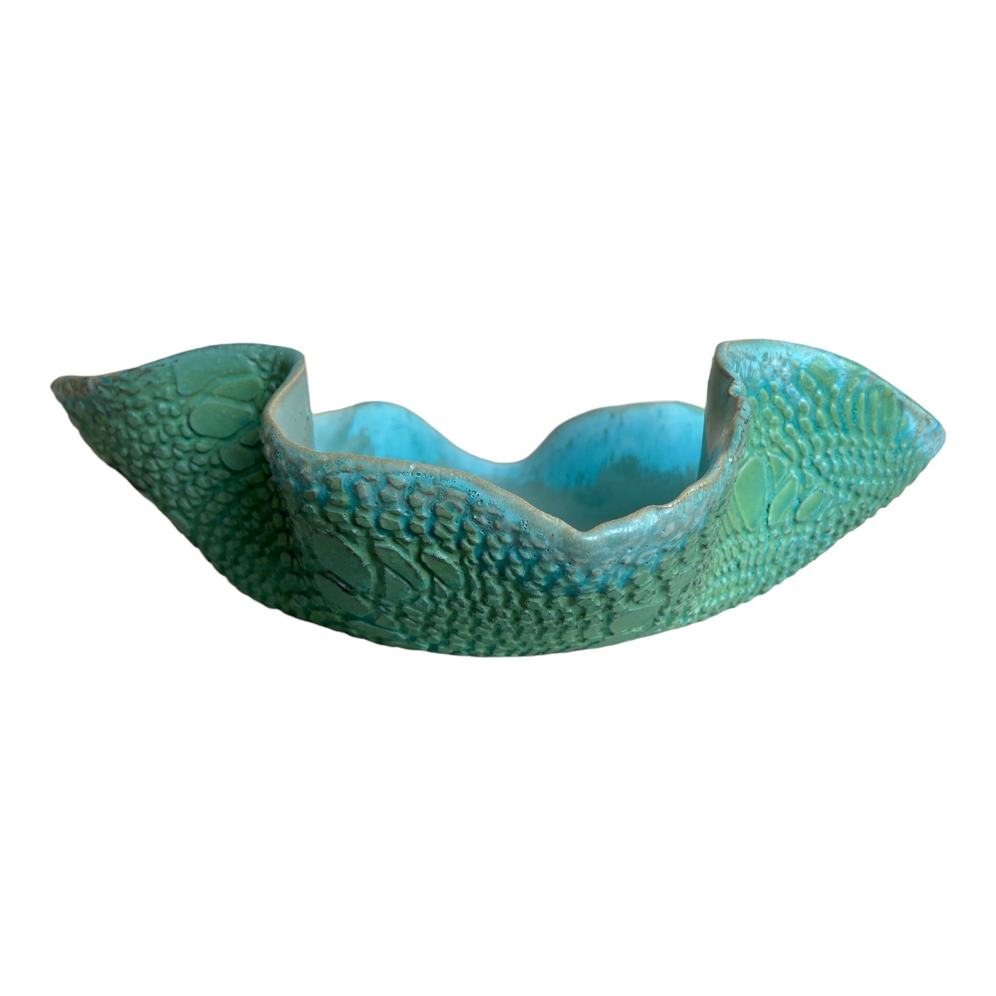 A custom, one-of-a-kind ceramic vessel with a green serpentine design, crafted by local Austin artist Rick Van Dyke.