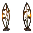 A pair of mid-century modern teak wood floor lamps with a tulip shape, featuring three light bulbs and handcrafted artisanal light bulbs, showing signs of wear and minor scratches.
Pair of sculptural teak lamps austin.