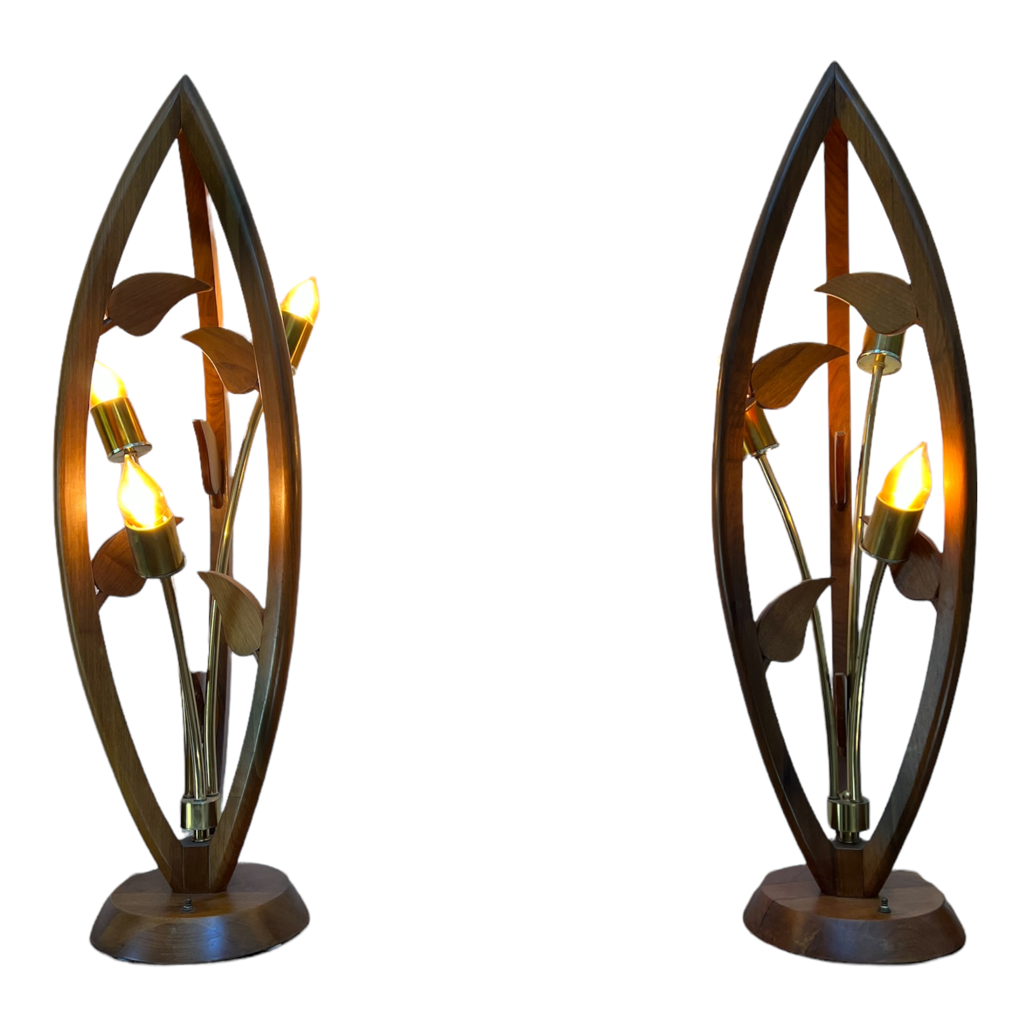 A pair of mid-century modern teak wood floor lamps with a tulip shape, featuring three light bulbs and handcrafted artisanal light bulbs, showing signs of wear and minor scratches.
Pair of sculptural teak lamps austin.
