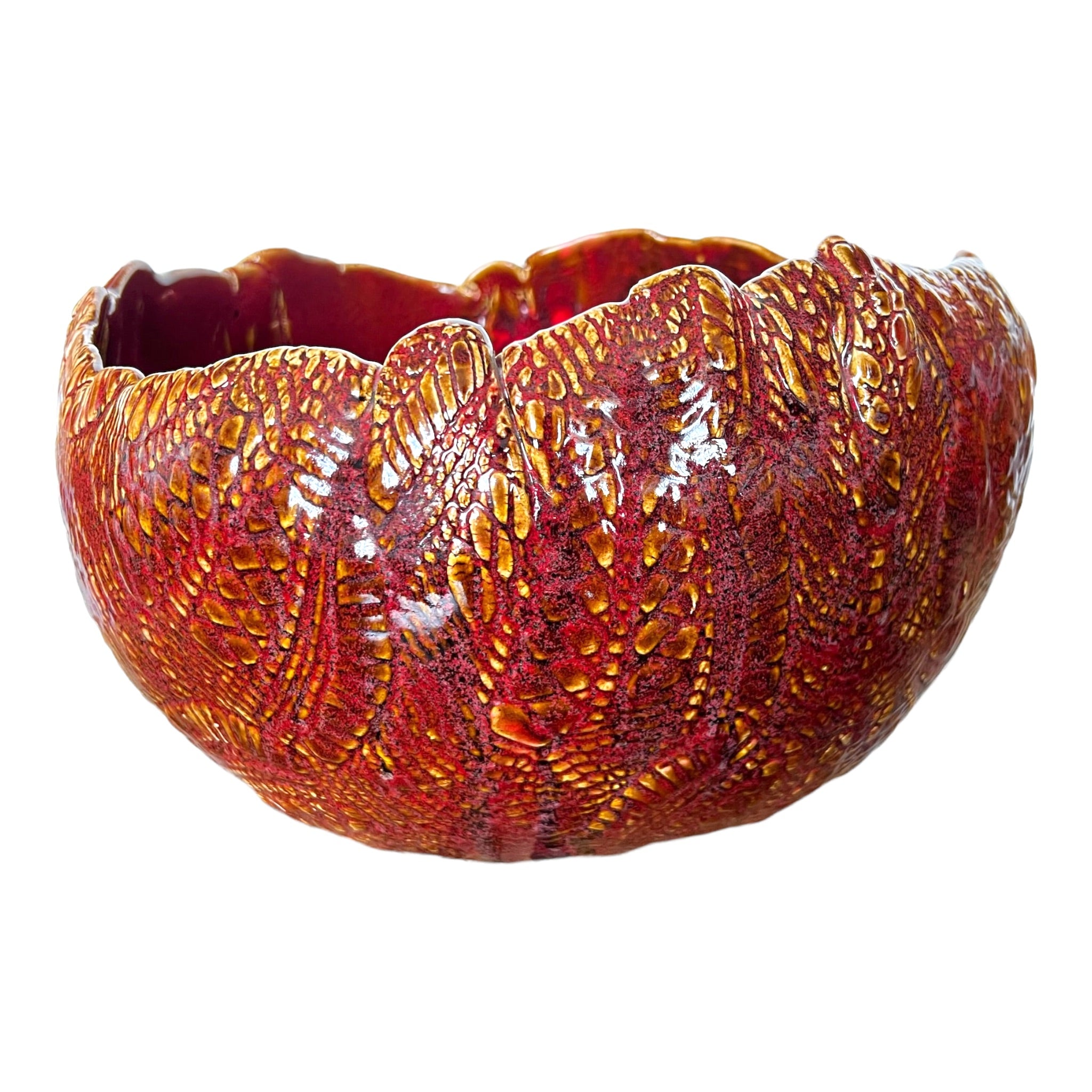 A multicolored ceramic serving vessel with a textured surface, primarily in red and orange tones by local artist Rick Van Dyke