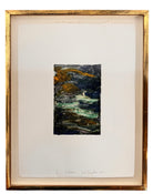 A vertical rectangular artwork, "Embers," by Jill London (2003), framed in a wide, textured gold frame. The piece features a small, abstract expressionist print at the center, rendered in dark, painterly strokes of deep blues, browns, yellows, and white, resembling moving water or smoke. Below the print, on the cream mat, the artist's signature, title, and date are hand-written in pencil. The paper has a delicate, textured deckled edge.