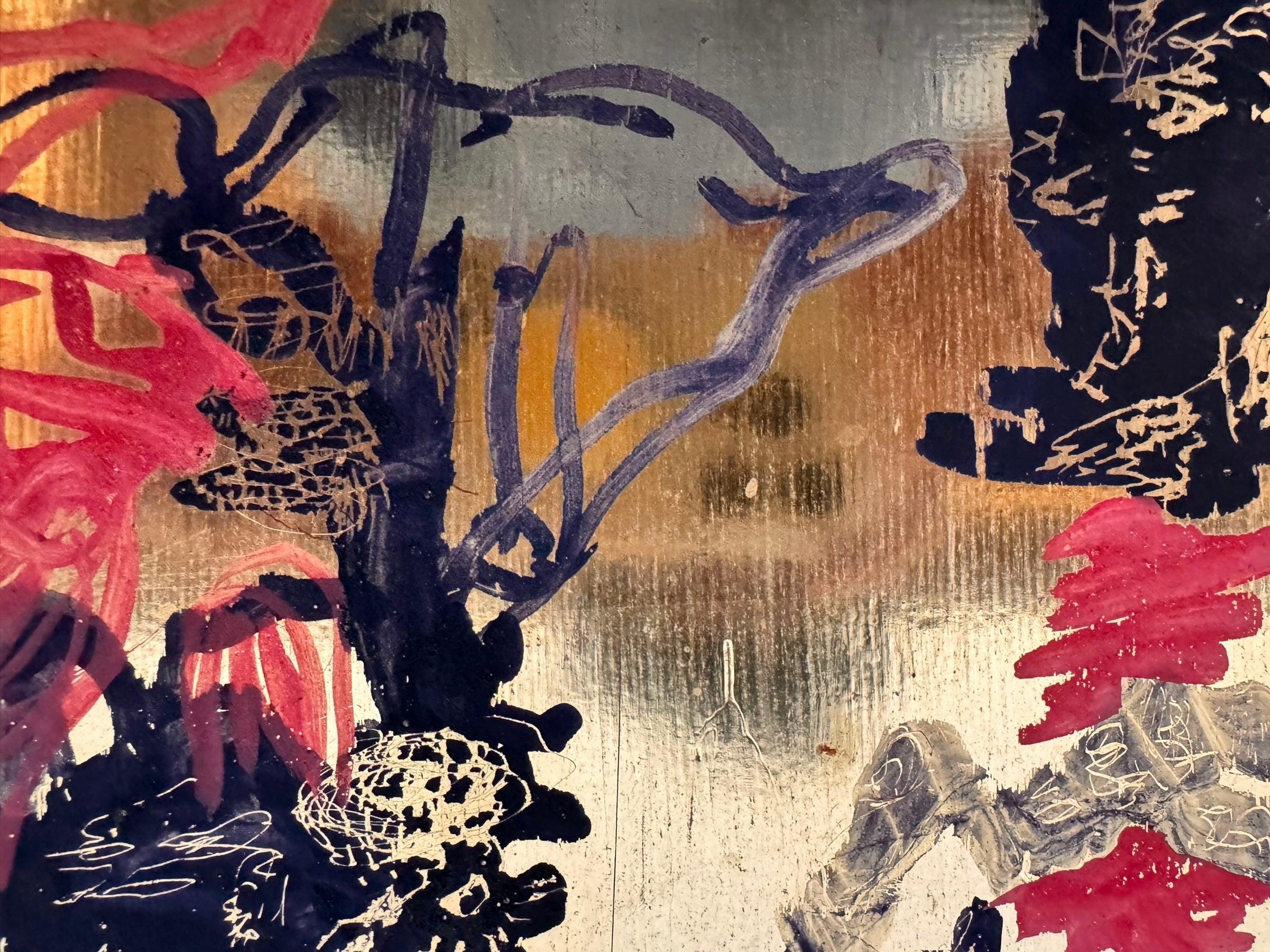 A vibrant abstract painting on a metallic gold-toned panel characterized by dense, energetic layering. The palette is dominated by saturated pinks, deep blacks, and earthy oranges.
In the upper half, horizontal strokes of orange and pink suggest a sunset or landscape, while the lower half features heavy, gestural applications of black paint that anchor the composition. Fine, white or silver linear scribbles are scratched into or layered over the pigment, adding a sense of frantic movement.