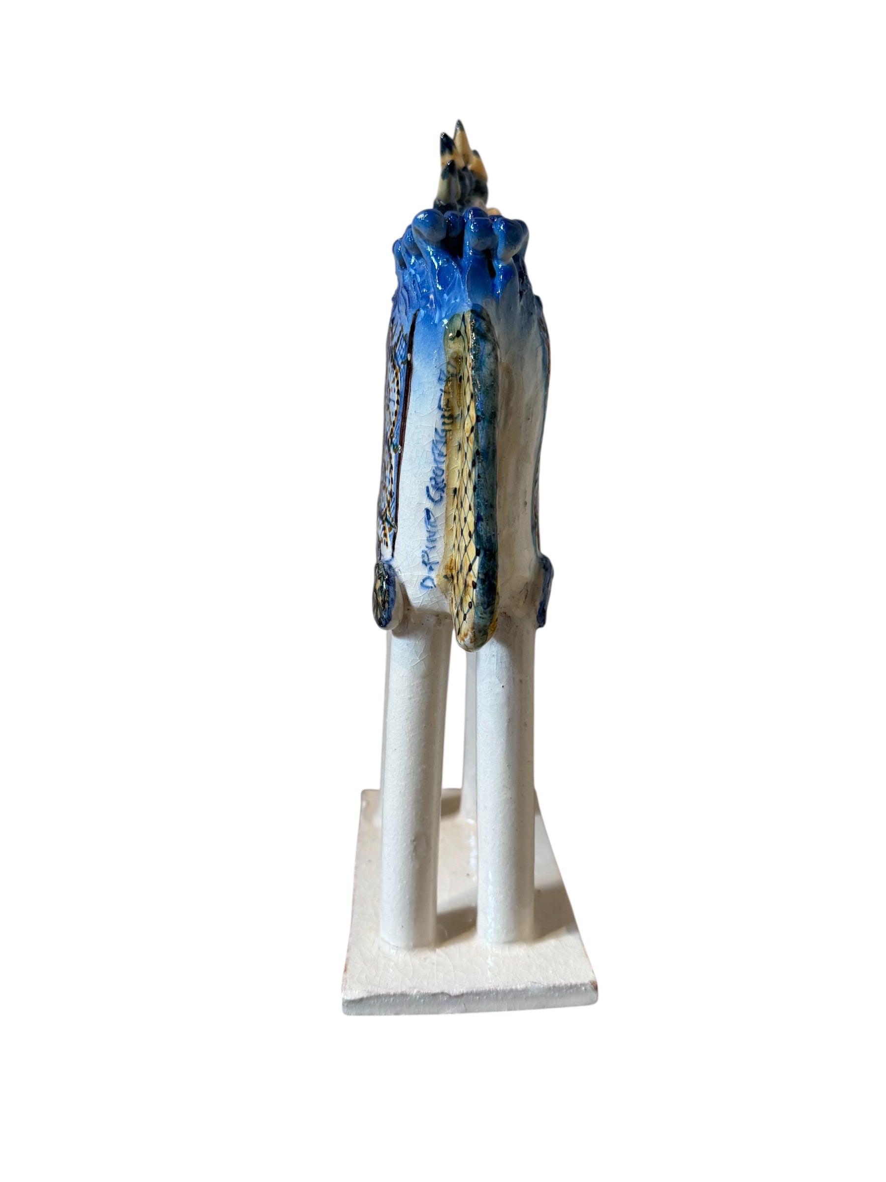Ceramic horse by Domenico Pinto, featuring a white glazed body, geometric quilting on the saddle, a decorative crown with black and gold accents, and 24Kt gold detailing. The horse stands on four legs and is placed on a white base.