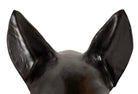 A smooth, dark black-colored ceramic sculpture of a Miniature Pinscher's head. The stylized dog features large, upright pointed ears and a prominent spiked collar around its neck. The surface has a soft sheen, with minimalist indentations for eyes and a rounded snout, creating a sleek and modern aesthetic.