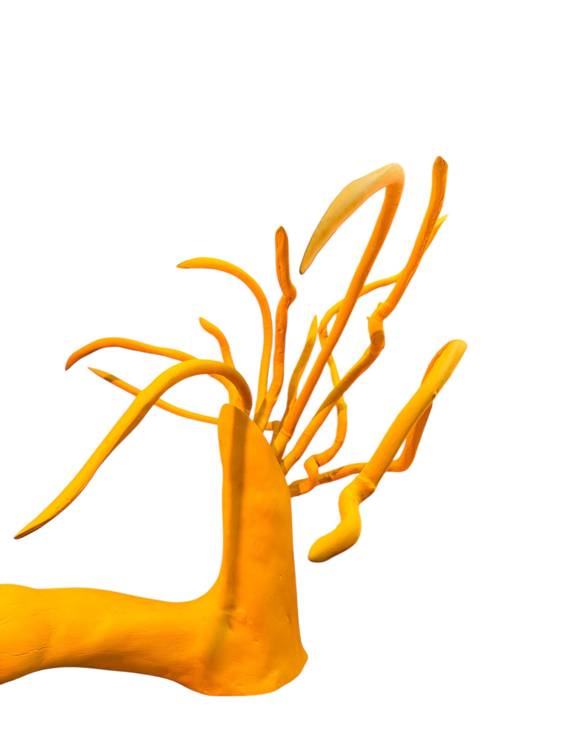 A bright yellow abstract sculpture depicting a calamari with a thick base and several thin, curving, branch-like extensions.