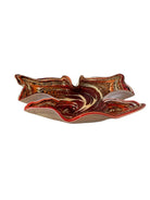 A Murano art glass bowl with a freeform shape, featuring layered swirls of brown, orange, and cream, accented with gold flecks. The bowl has a translucent white base.