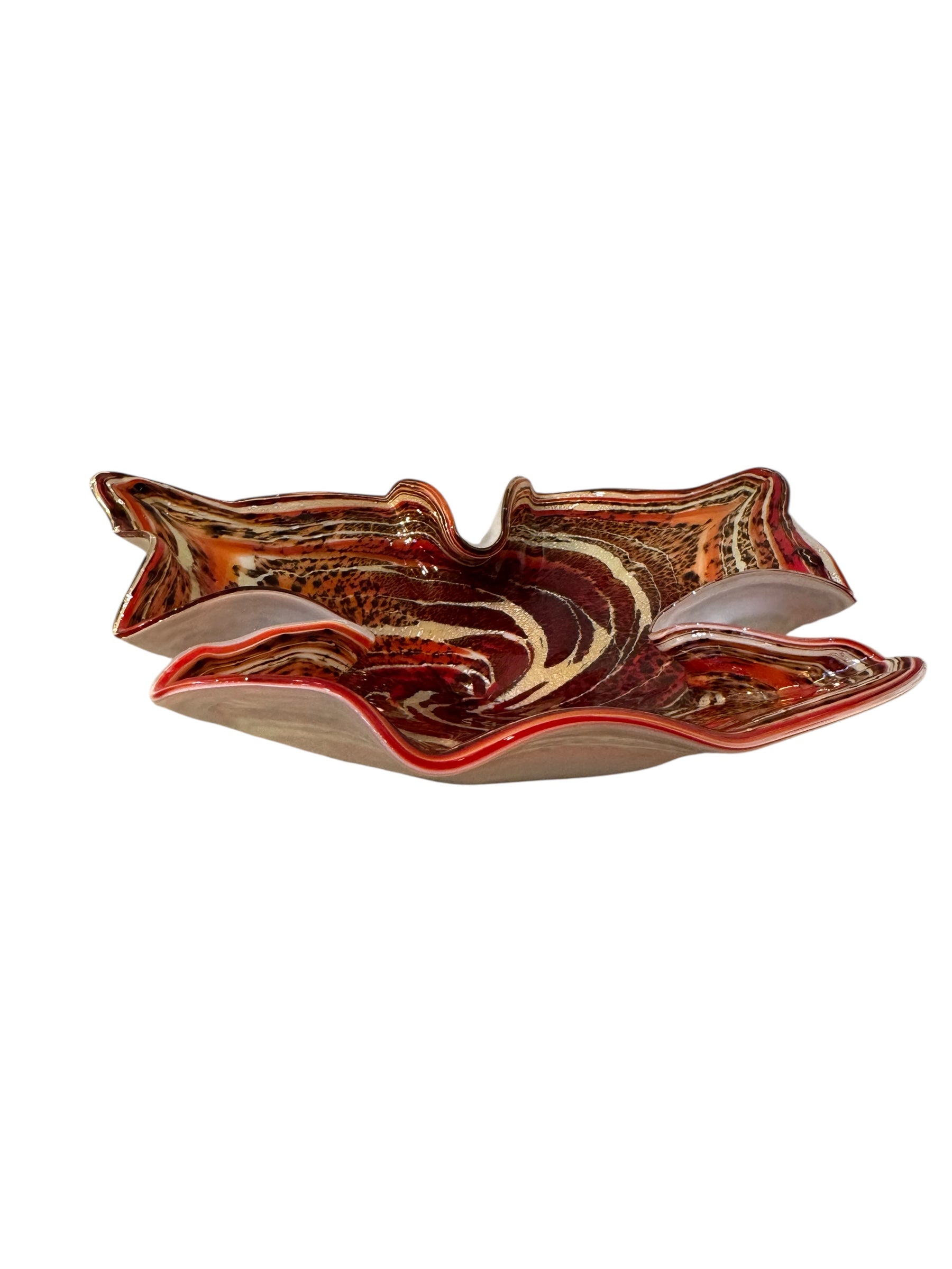 A Murano art glass bowl with a freeform shape, featuring layered swirls of brown, orange, and cream, accented with gold flecks. The bowl has a translucent white base.