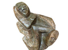 Figural sculpture in the Shona style, Zimbabwe. Two abstracted figures are intertwined, carved from greenish-brown soapstone. Sculpture rests on a dark iron stand.