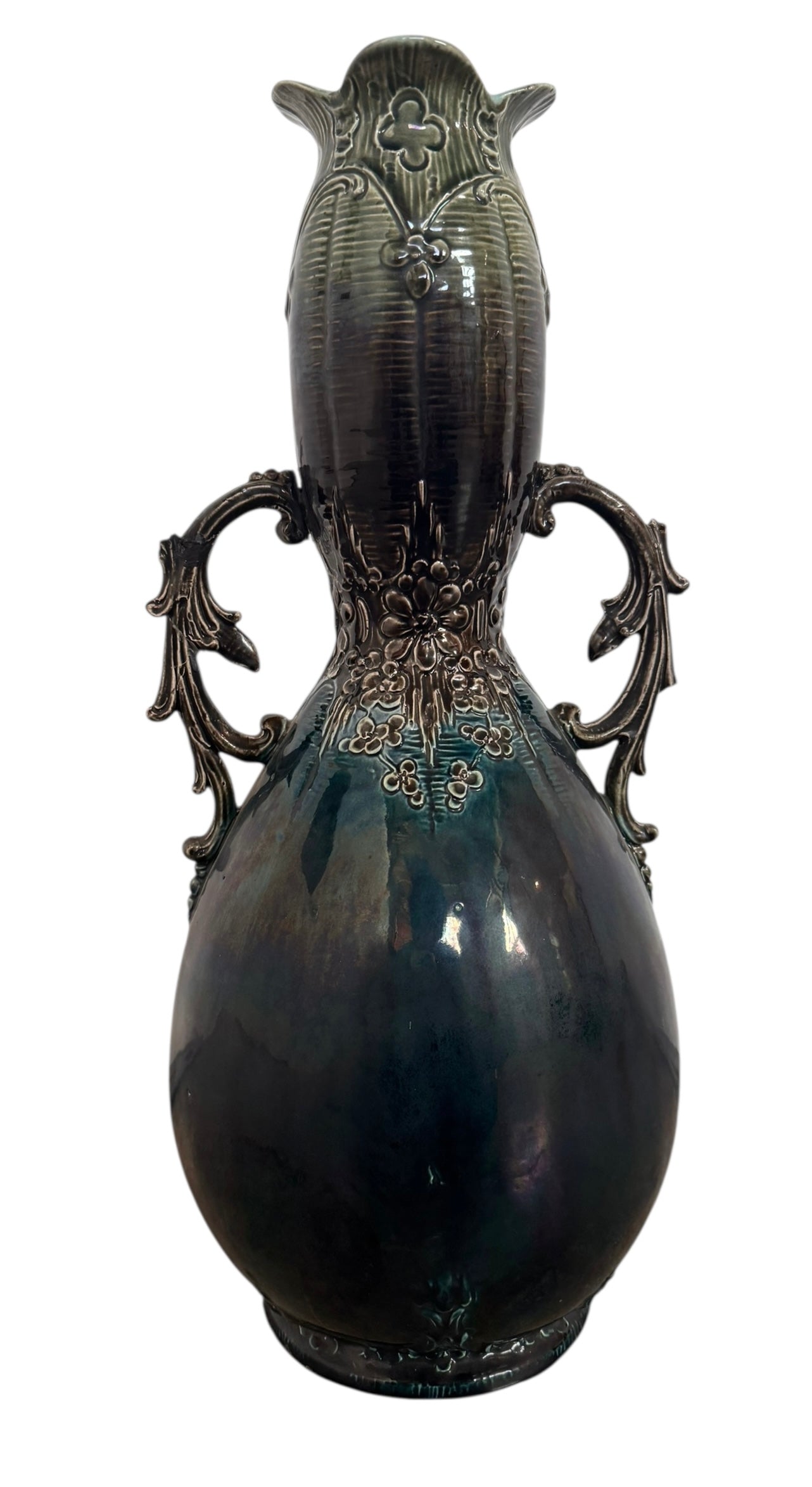 An ornate, dark glazed ceramic Art Nouveau vase with two handles and raised floral designs in yellow, purple, and green.