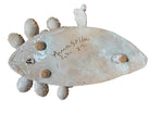 A white and orange, glazed ceramic platter in the shape of a prickly pear cactus pad with attached prickly pear fruit. The surface has raised dots representing spines. 