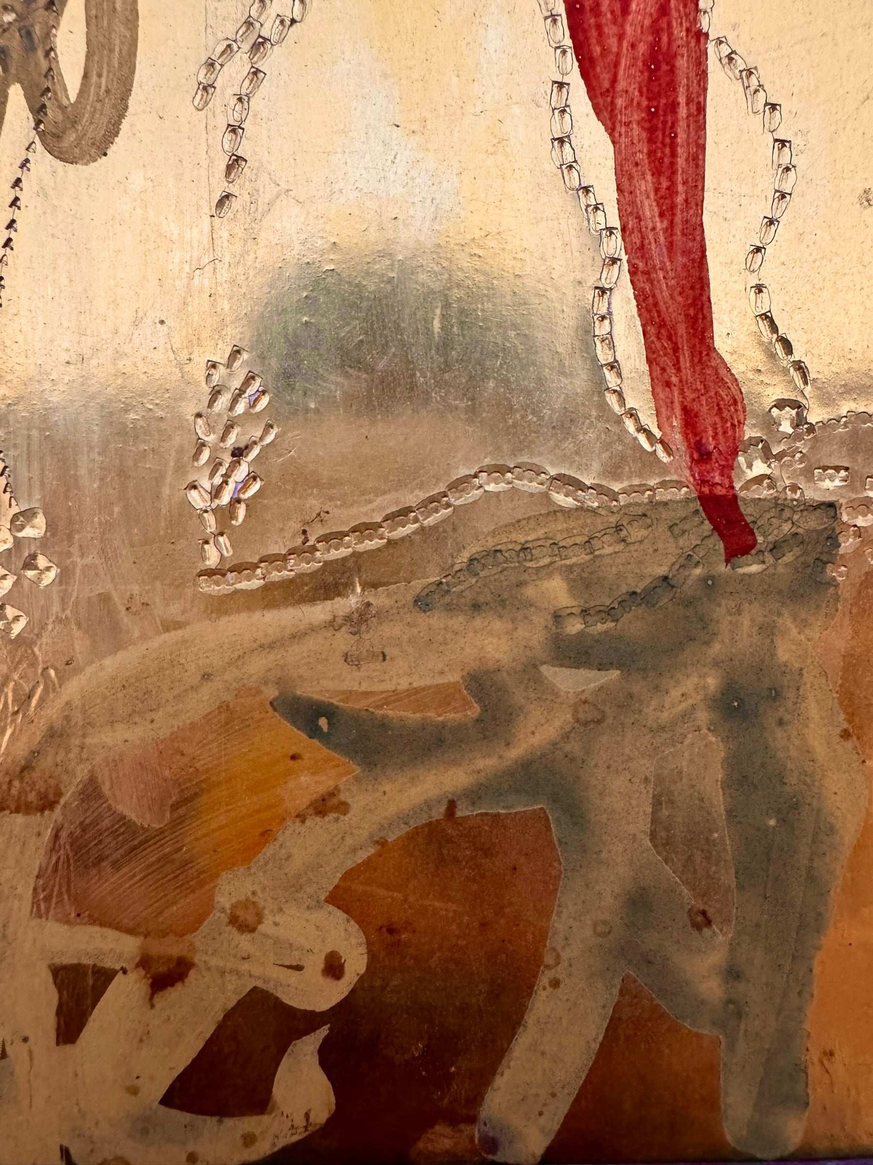 A vertical abstract work on a weathered gold-leaf panel. The upper section features bold, dark red calligraphic symbols resembling distorted kanji or script. Below, delicate, dotted white lines wind through the composition like strings of pearls or constellations. A slender, vertical form in vibrant red stands on the right, while muted, smoky-grey washes of paint ground the bottom of the piece.