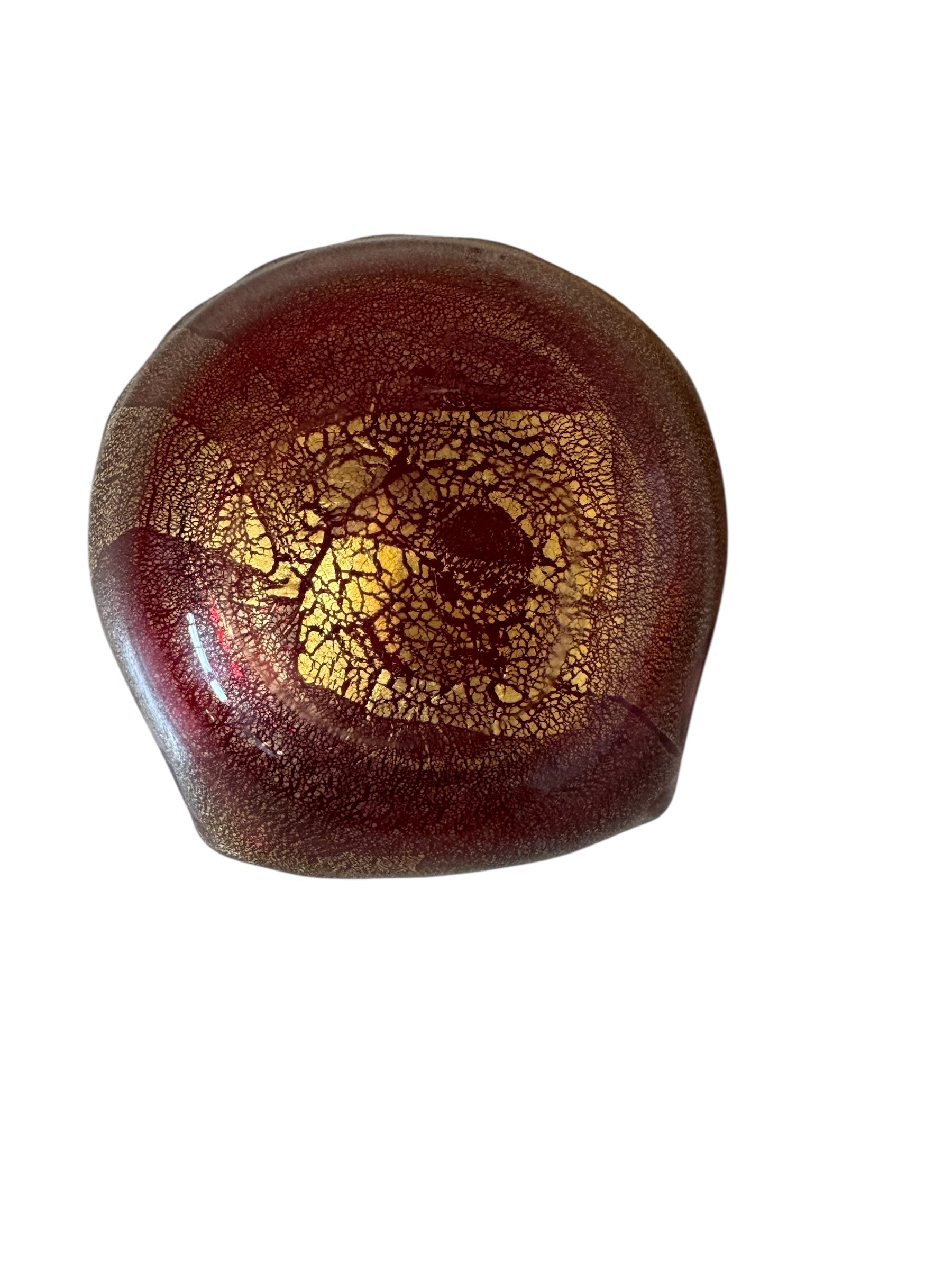 A handcrafted Murano glass bowl with a ruffled edge, deep red color, and gold specks created using the "oro zecchino" technique. The surface has a crackled gold pattern that reflects light, making it a striking decorative piece.