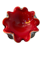 A Murano art glass bowl featuring a vibrant red interior encased in white glass, with a decorative ruffled edge. The piece is handblown, showcasing the Incamiciato technique.