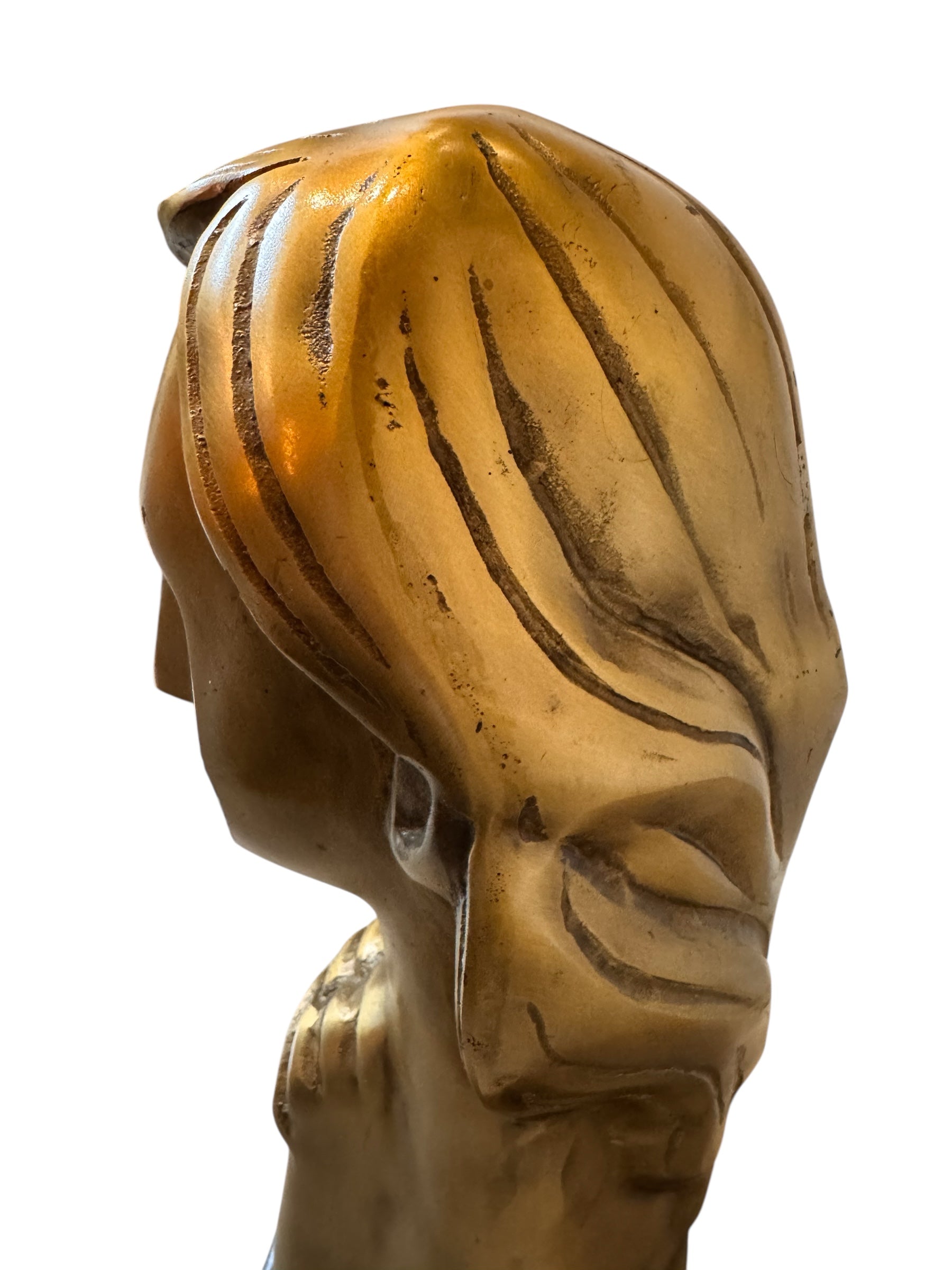 Cast bronze bust of a woman, mid-century Korean design, on a dark wood base. The figure has stylized flowing hair and no mouth.