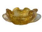 A  vintage Italian Murano glass bowl with a yellow hue, gold Aventurine inclusions, and a bubbly (Bullicante) texture. The bowl is flower-shaped with crimped edge