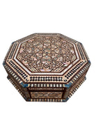 An ornate octagonal Syrian inlaid box, intricately decorated with geometric patterns made from dark wood, iridescent mother-of-pearl, vibrant abalone shell, and pale bone