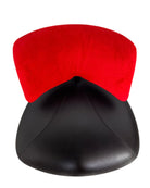 A Leolux Pallone armchair with a large, black, spherical leather seat and a smaller, red, curved leather backrest, supported by short metal legs.