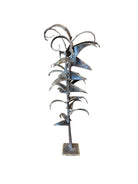 Mid-century Brutalist sculpture made of brass and bronze, depicting a stylized plant with textured, oxidized surfaces.